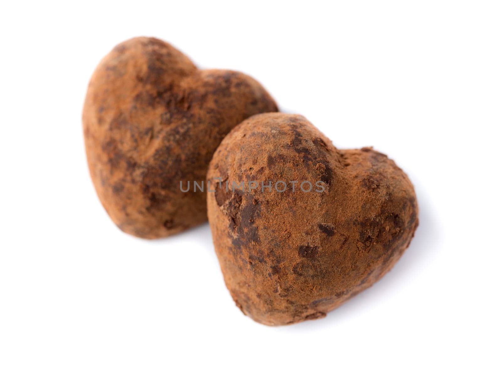Two candy truffle heart shaped. Isolate on white. Symbols of Valentine's Day.