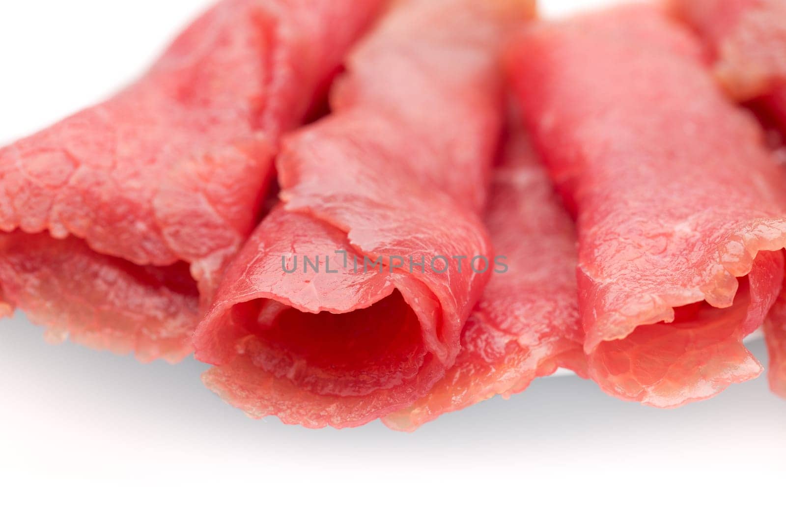 Smoked meat laid on a plate. Isolate on white.
