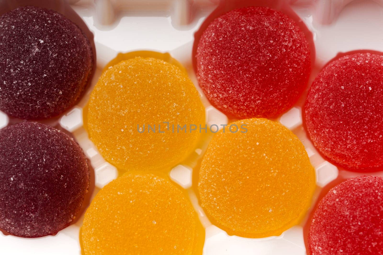 Round jelly sprinkled with sugar in a plastic box