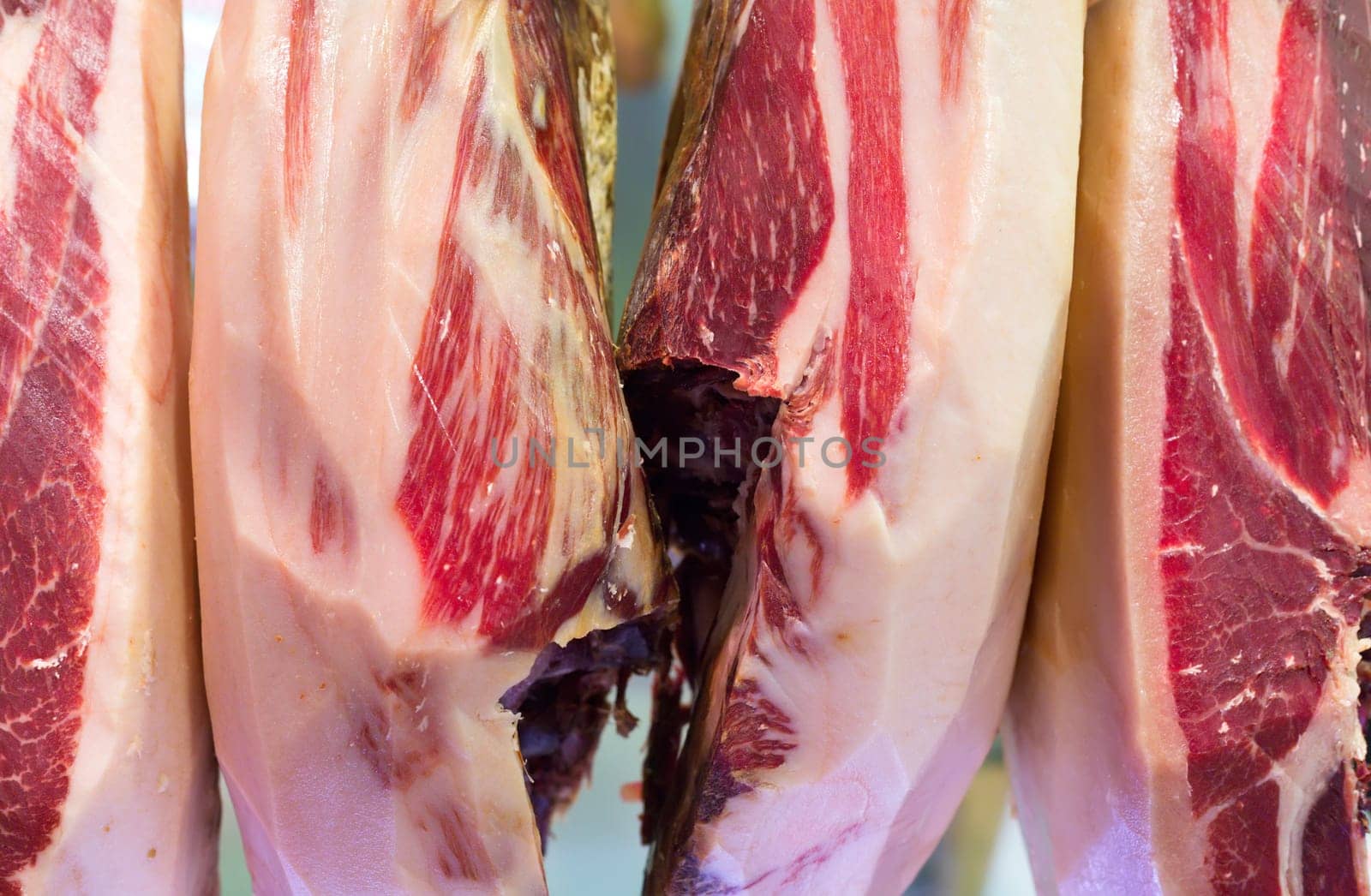 Jerk ham hanging in a store, Barcelona, ​​Spain. Submitted to National dish.