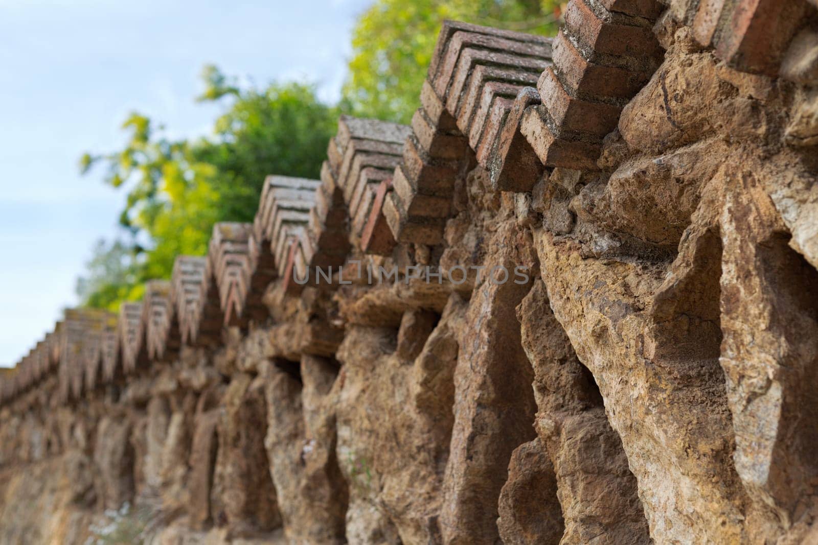 Fence of old stones in a park in Barcelona, ​​Spain.