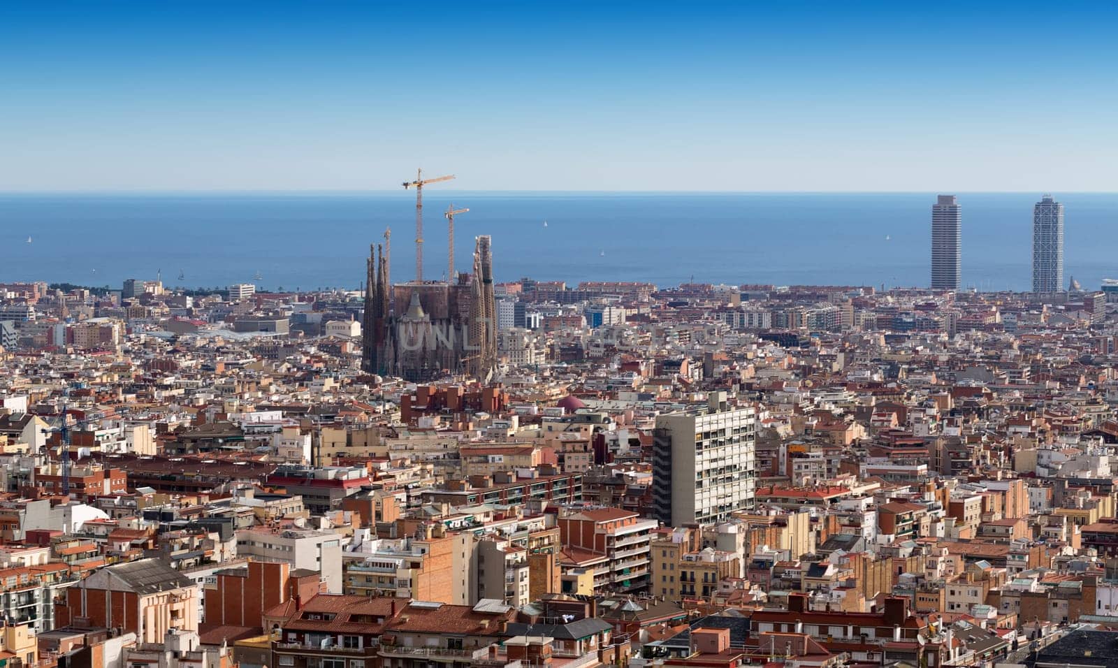 A skyline of Barcelona with a view of Tibidabo mountain.