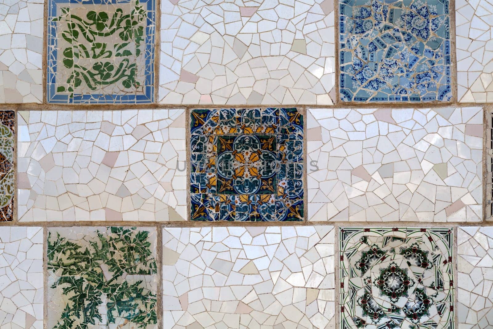 Detail of a mosaic on the wall. Close-up of the ceramics in Park Guell Barcelona created by Gaudi