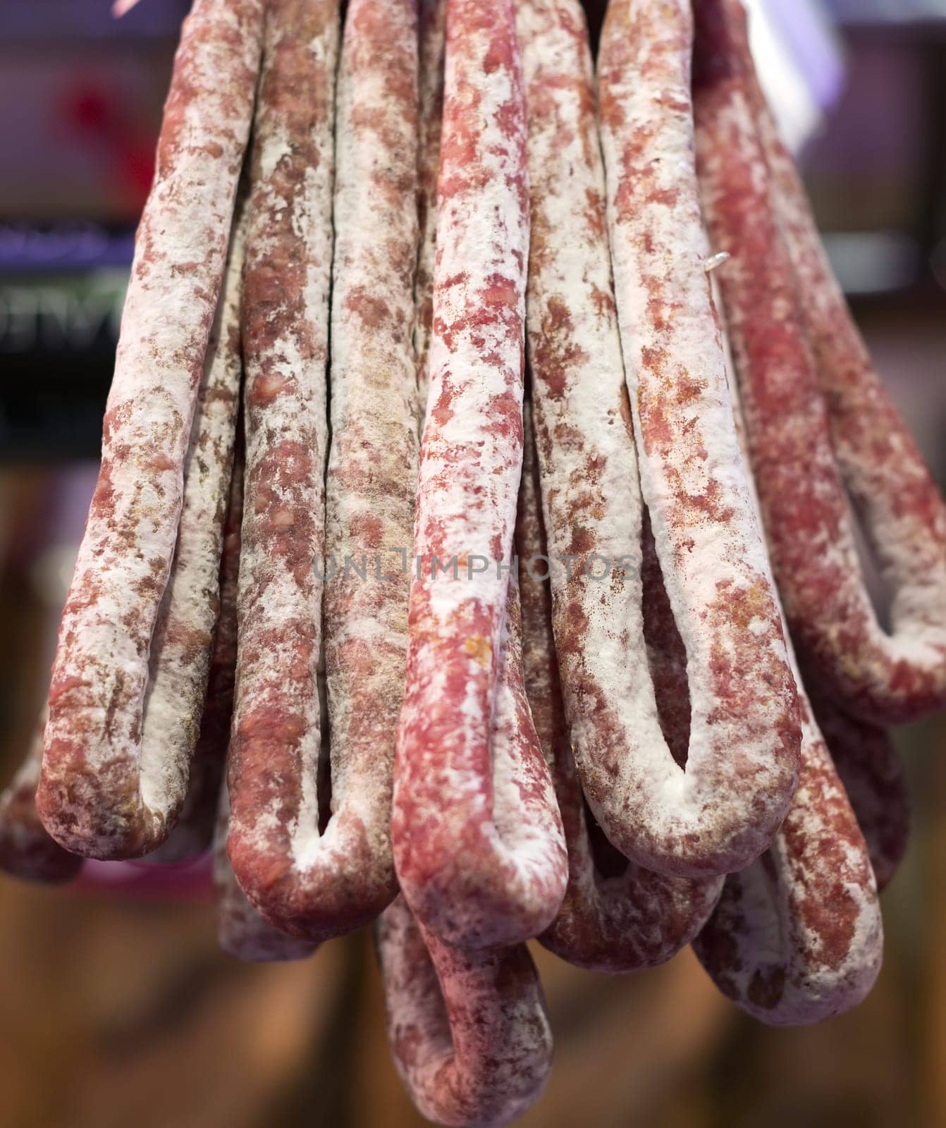 Fuete sausage hanging on a market in Barcelona.
