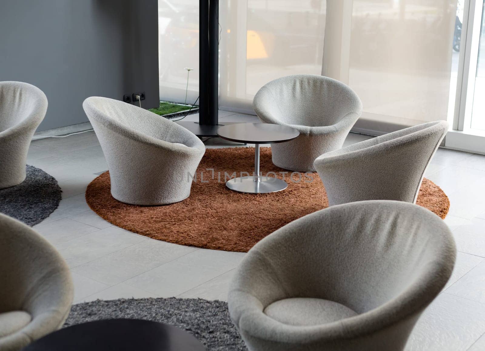 Lounges, chairs and carpets on the marble floor.
