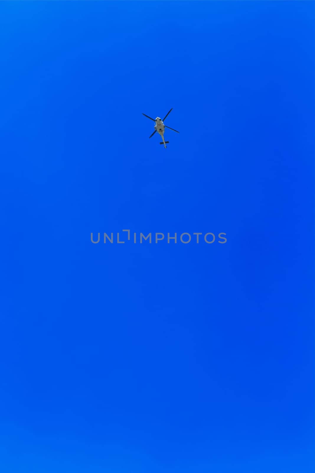 Helicopter in the air across clear sky