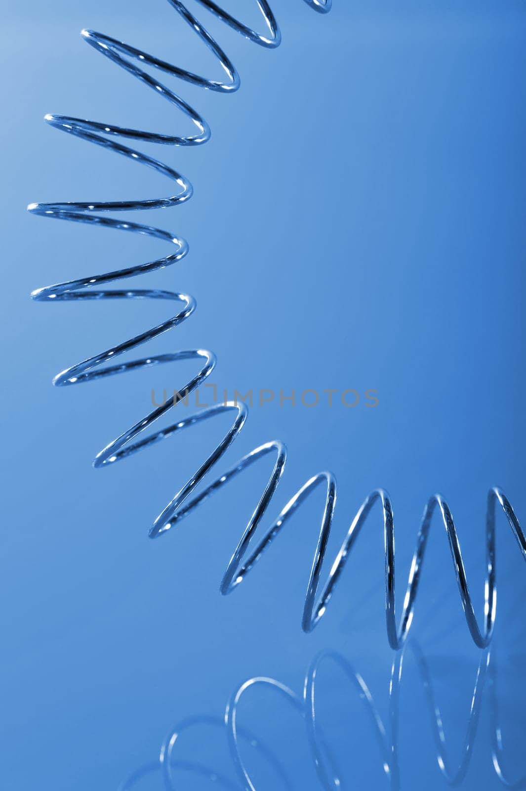 Chrome spiral bent on blue background