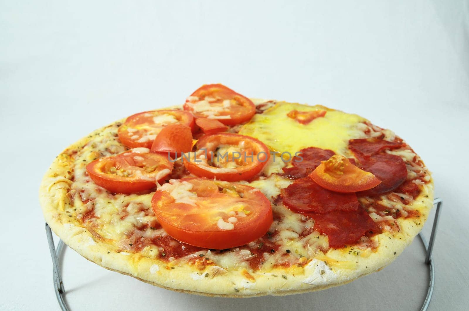 Cooked Mixed Italian Pizza over a White Background