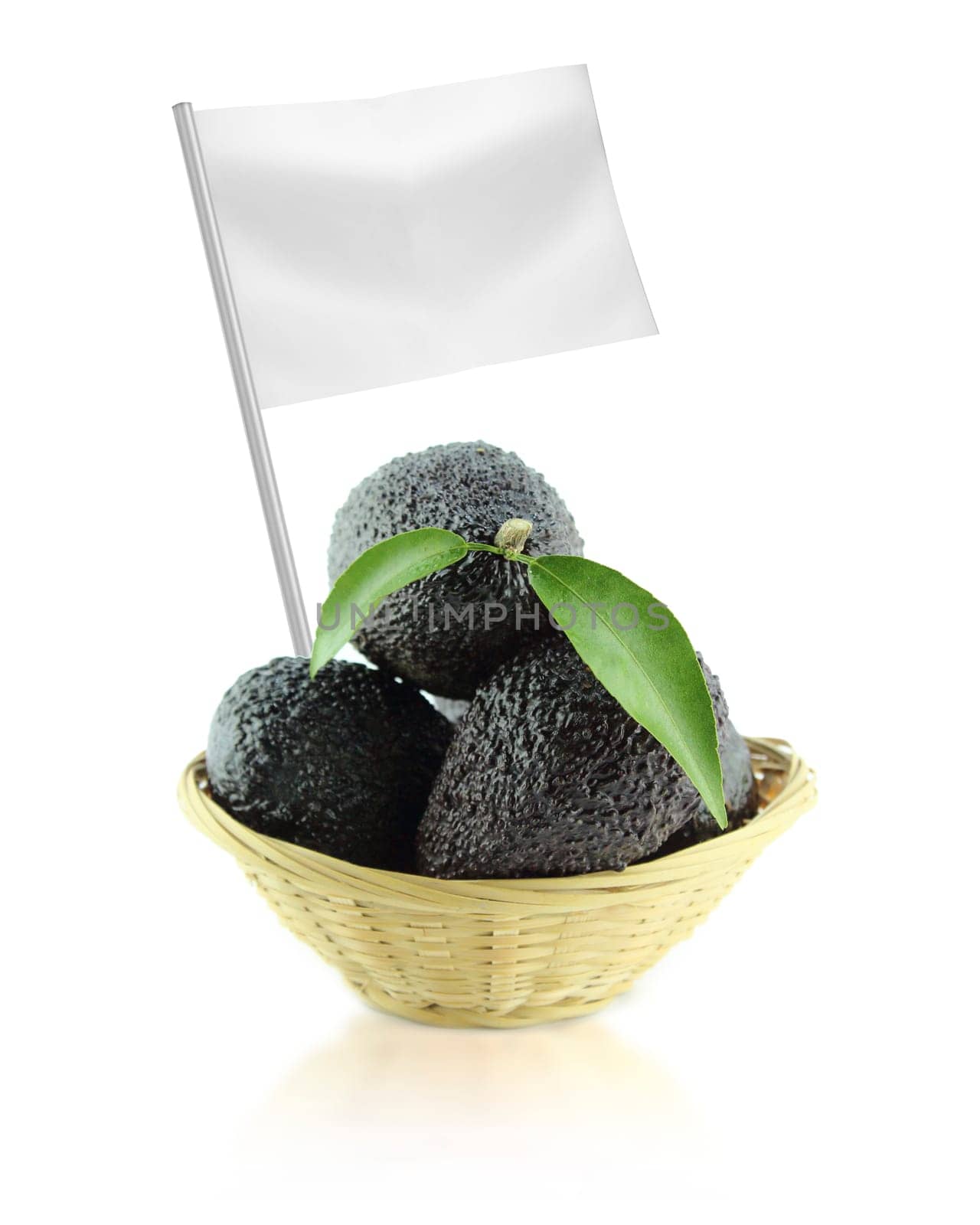 Healthy and organic food concept. Fresh Avocados with leaves on a Dish of straw with flag showing the benefits or the price of fruits.