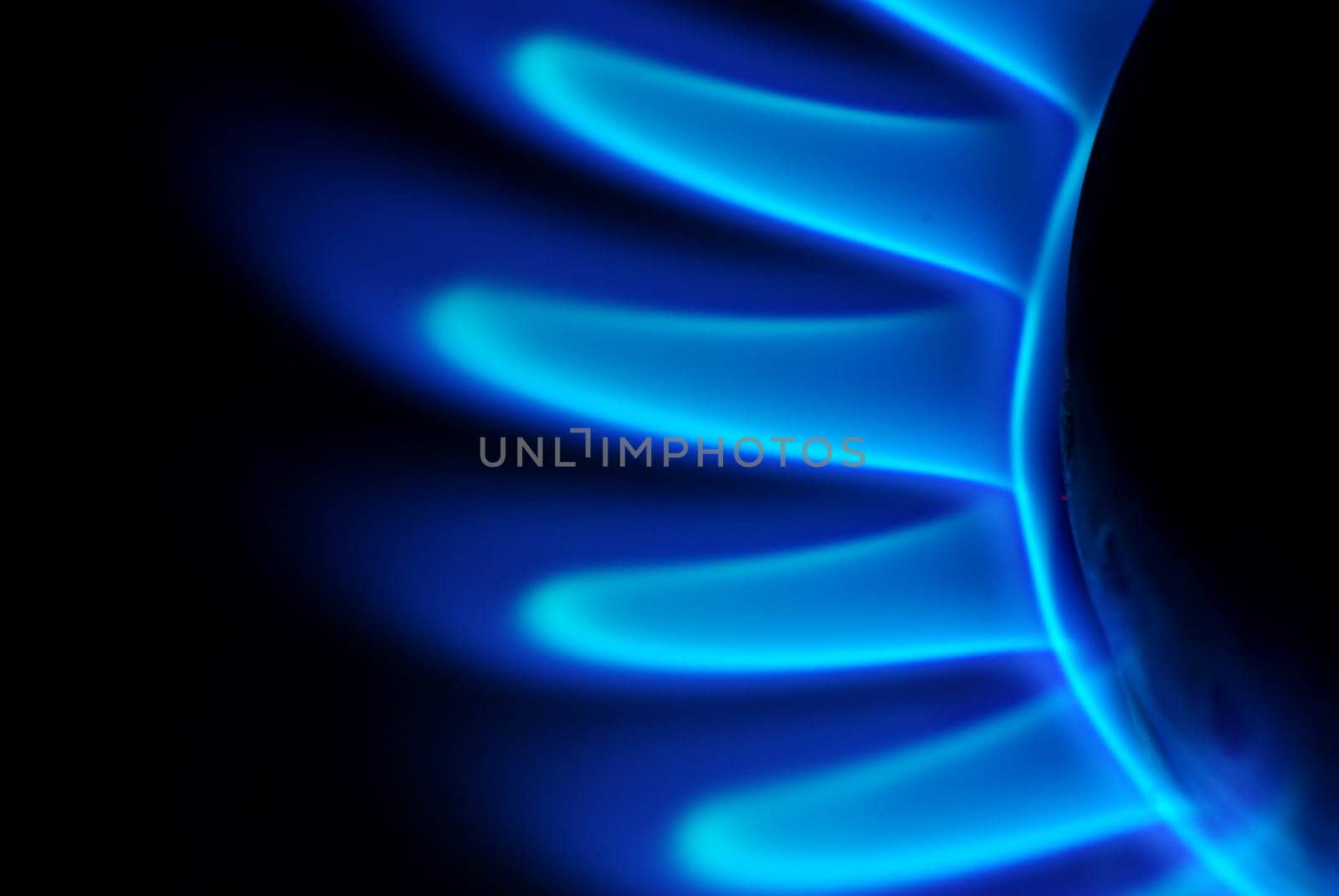 Blue flames of gas stove in the dark