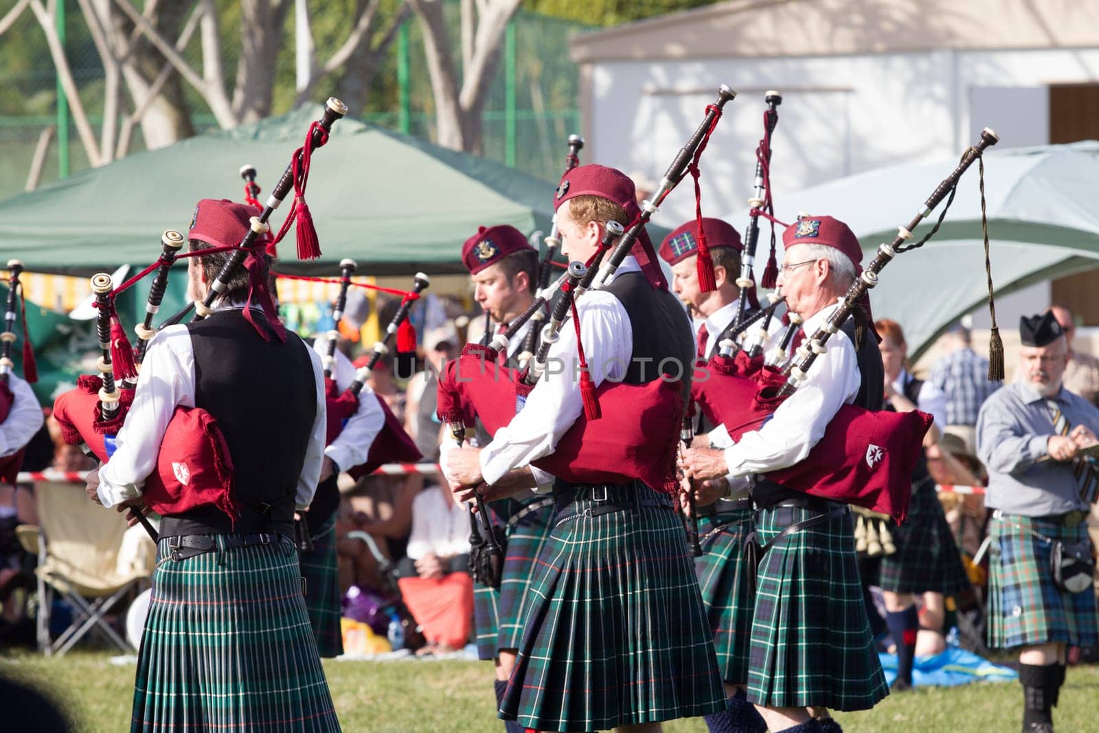Scottish bands men and women play musical instruments in traditional Scottish clan colors dress at the Scottish Highland Gathering in Toti Durban South Africa
