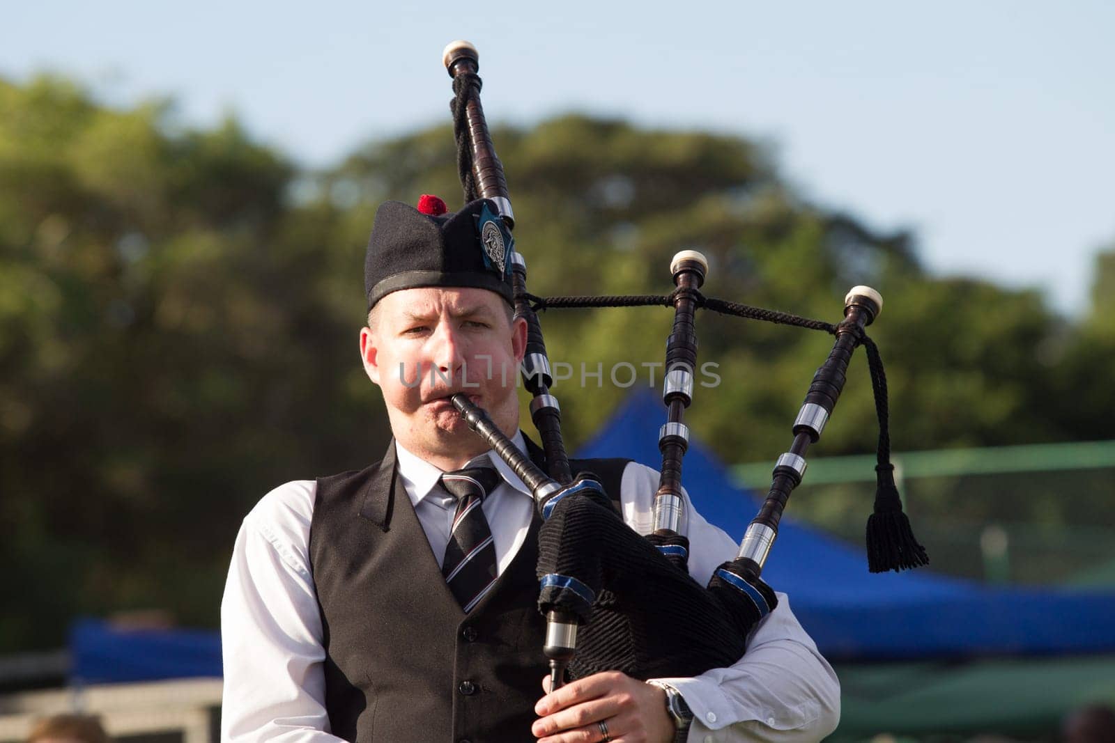 Scottish bands men and women play musical instruments in traditional Scottish clan colors dress at the Scottish Highland Gathering in Toti Durban South Africa