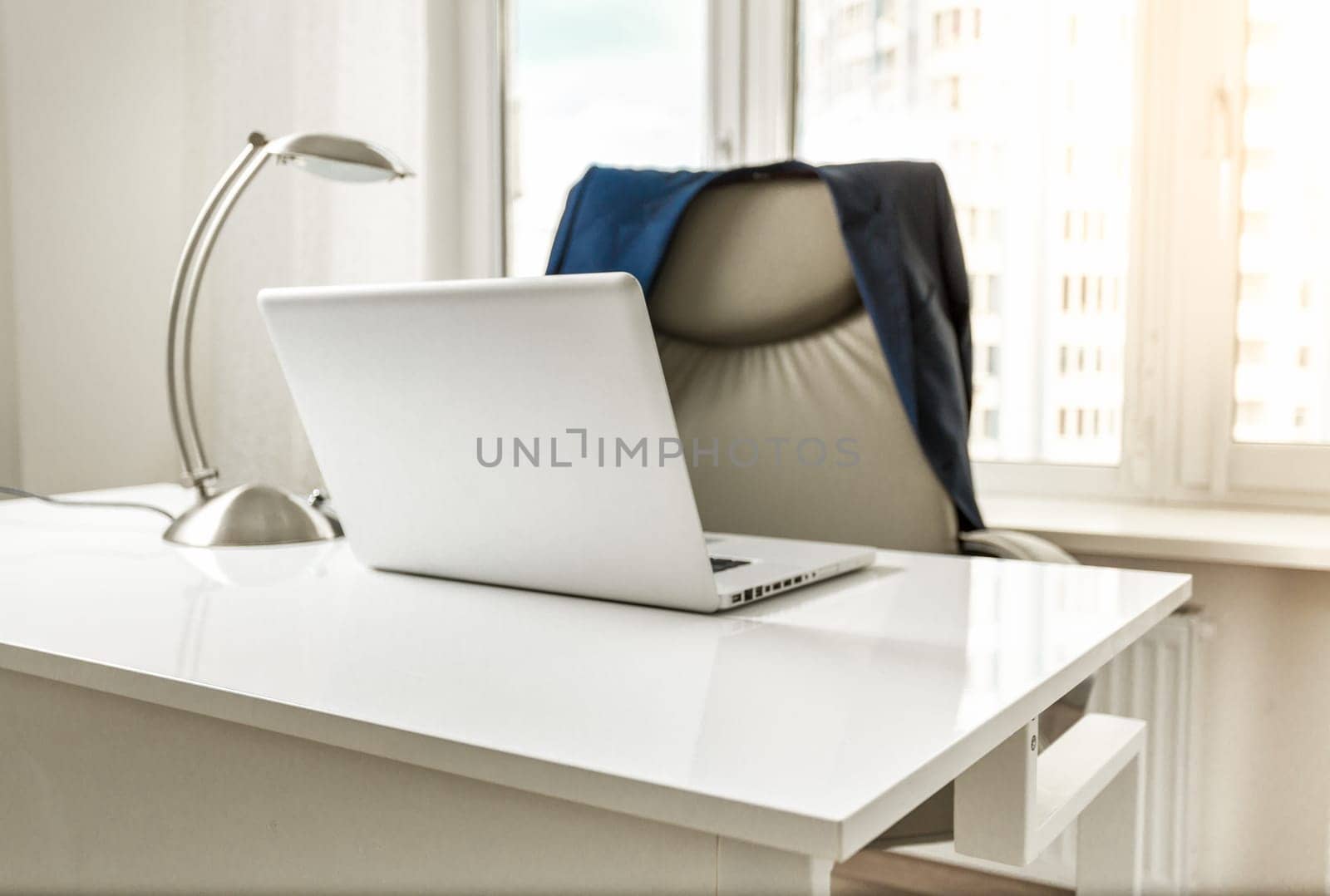 Interior photo of jacket hanging on chair at office