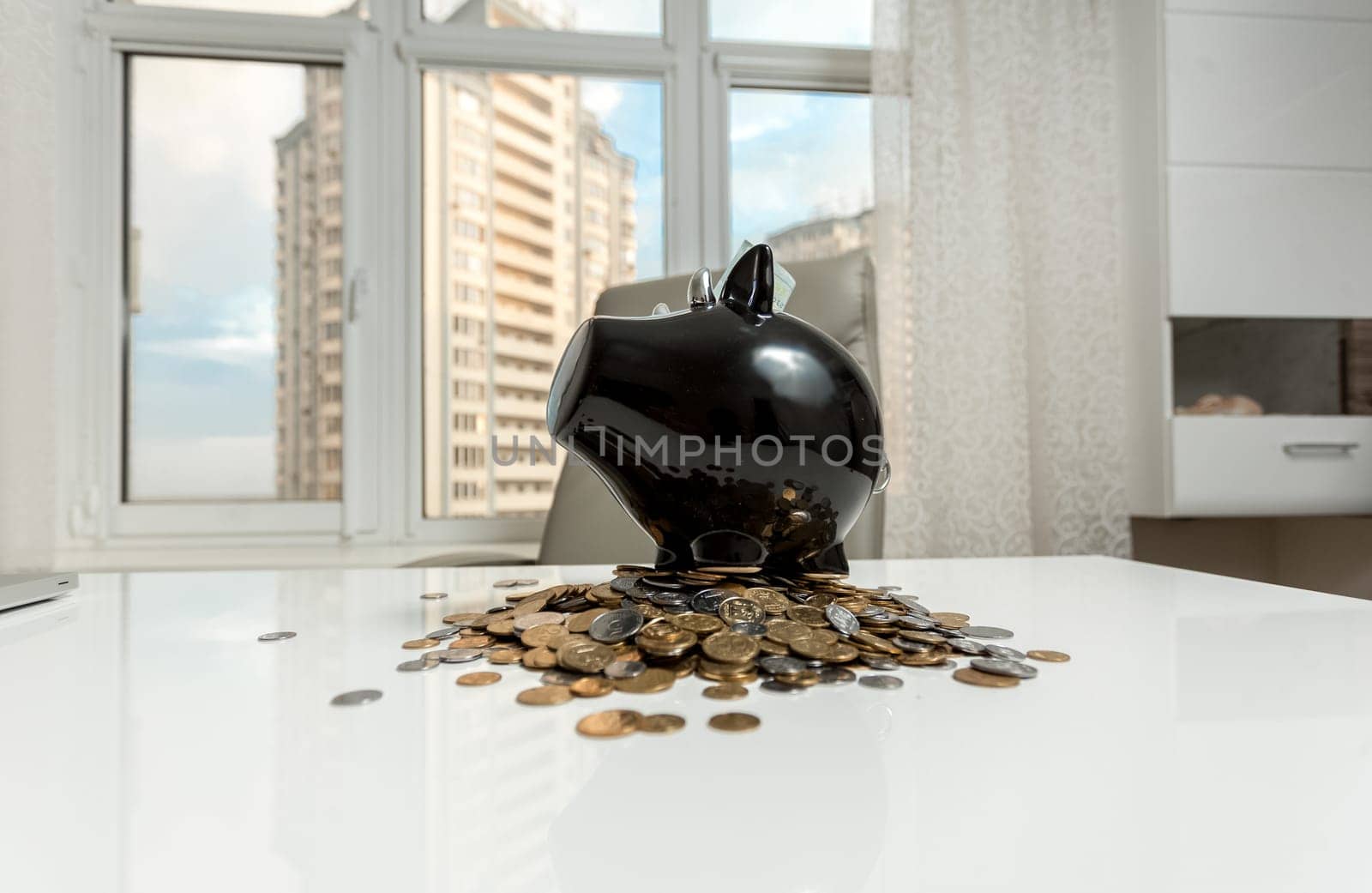 Photo of piggy bank on office table against city view