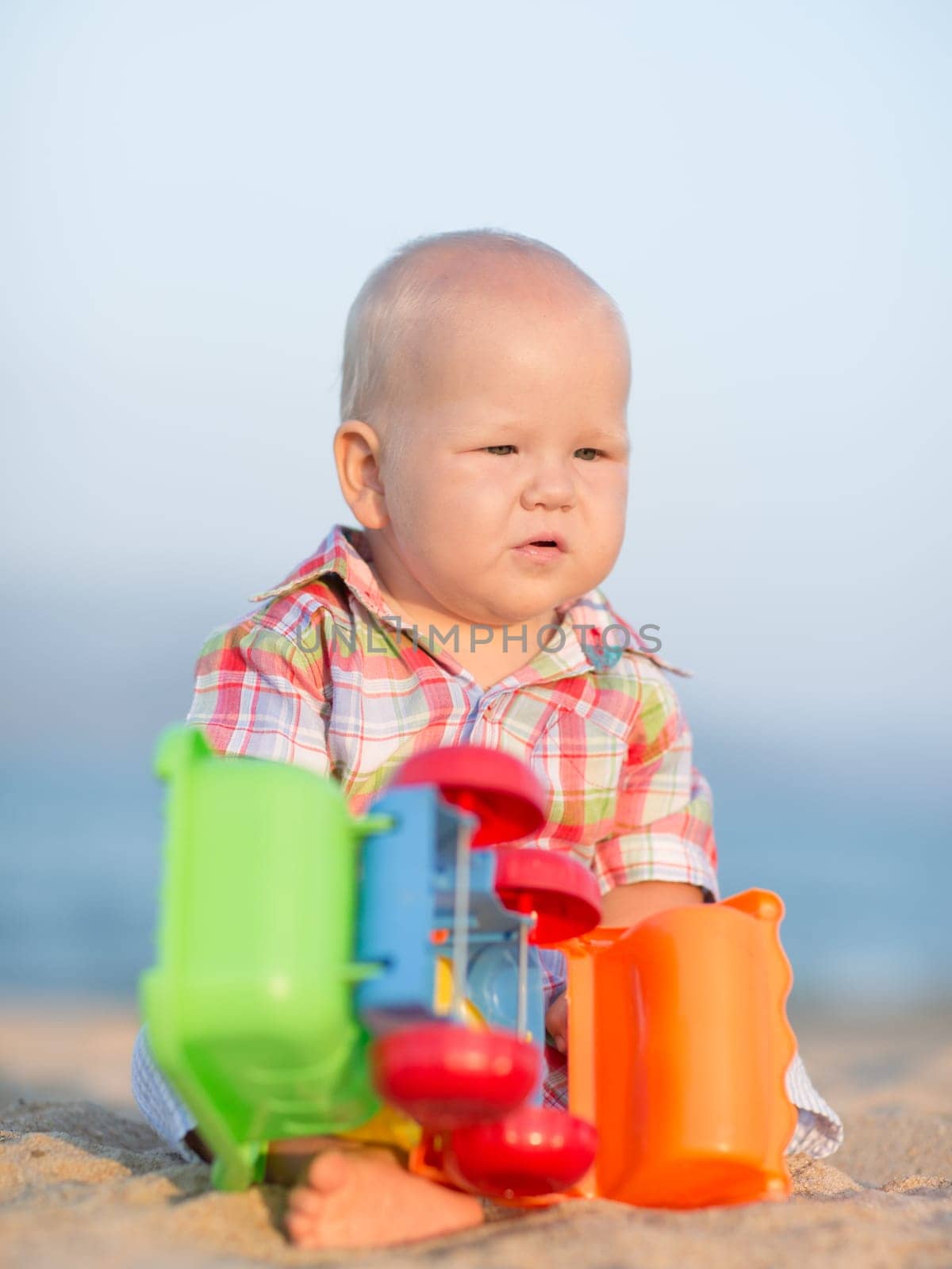 Cute baby is playing toy car