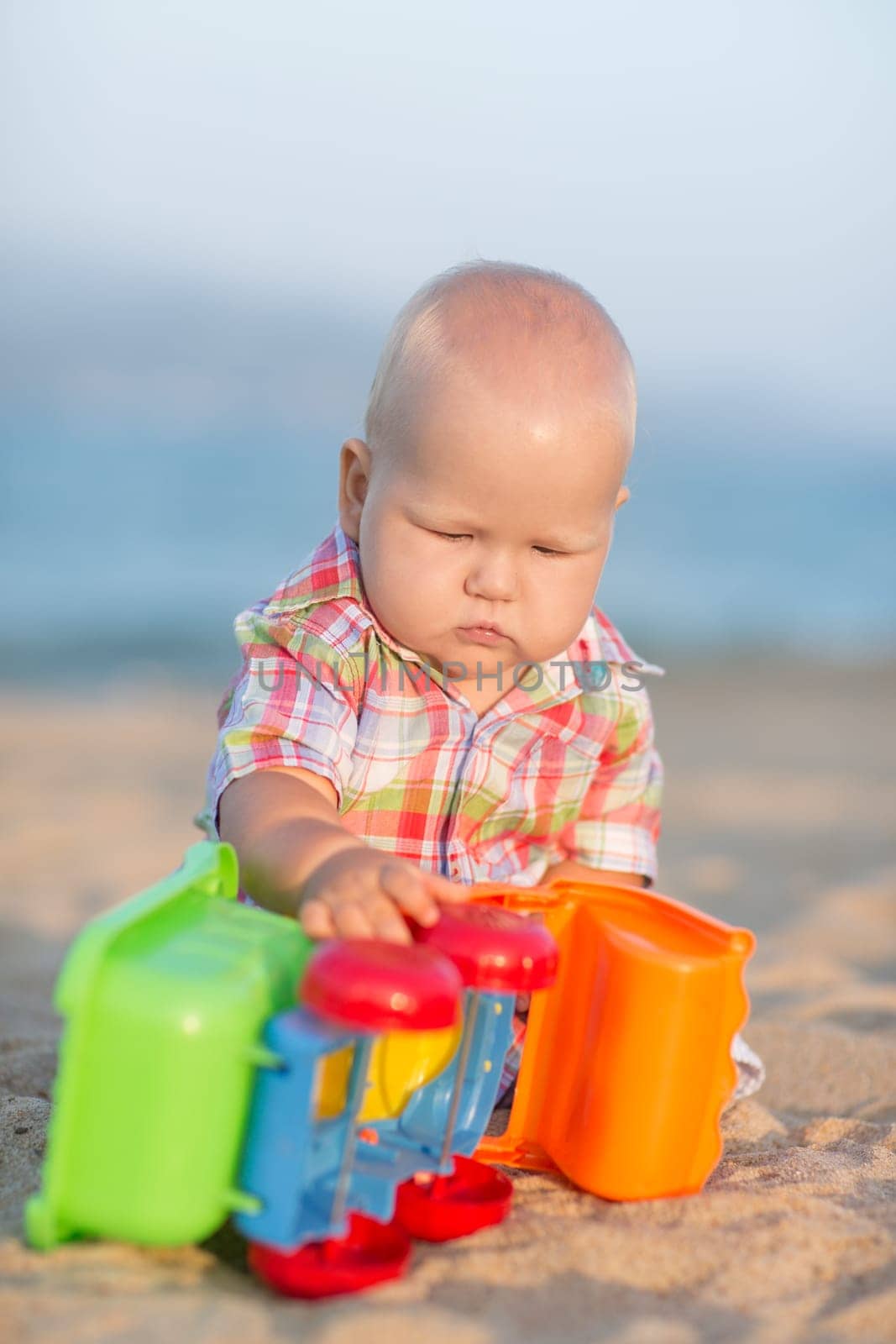 Cute baby is playing toy car