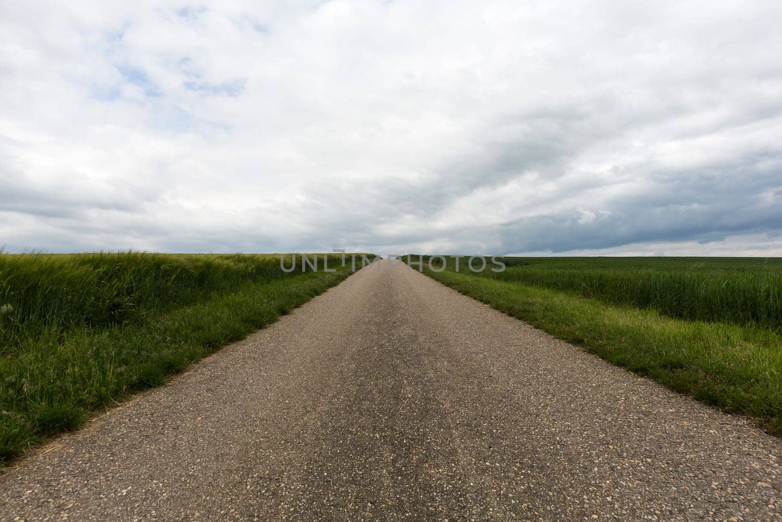 Road to nowhere,asphalt cuts through the landscape with horizon