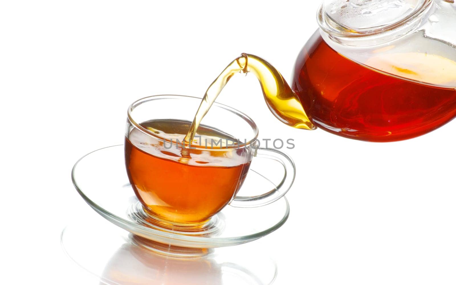 Tea being poured into glass tea cup