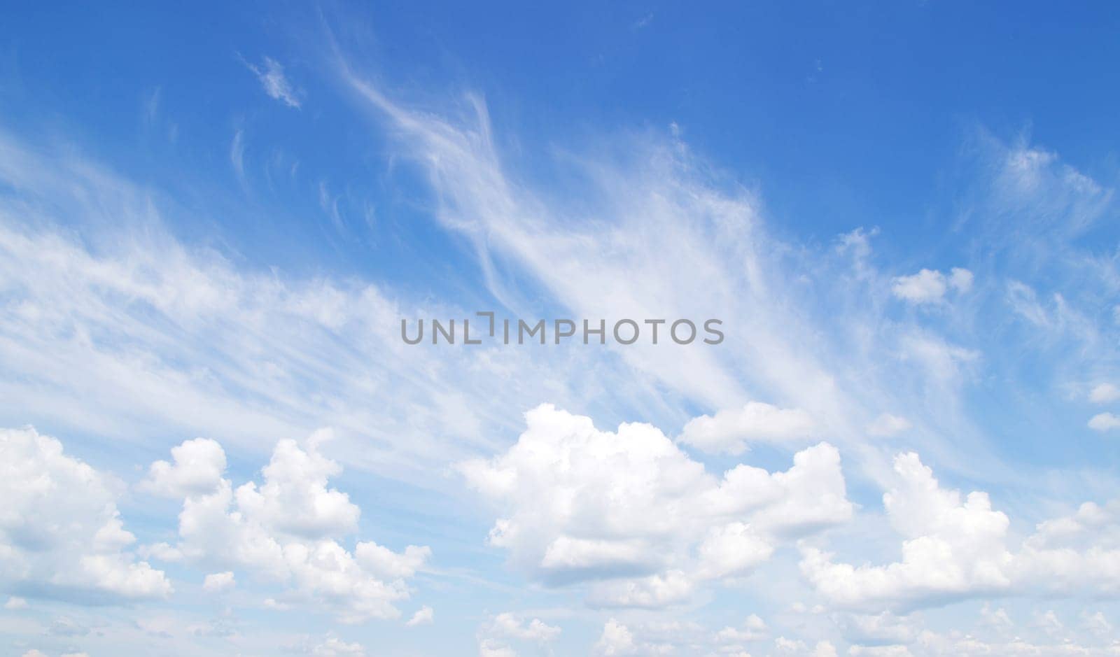 Blue sky background with tiny clouds