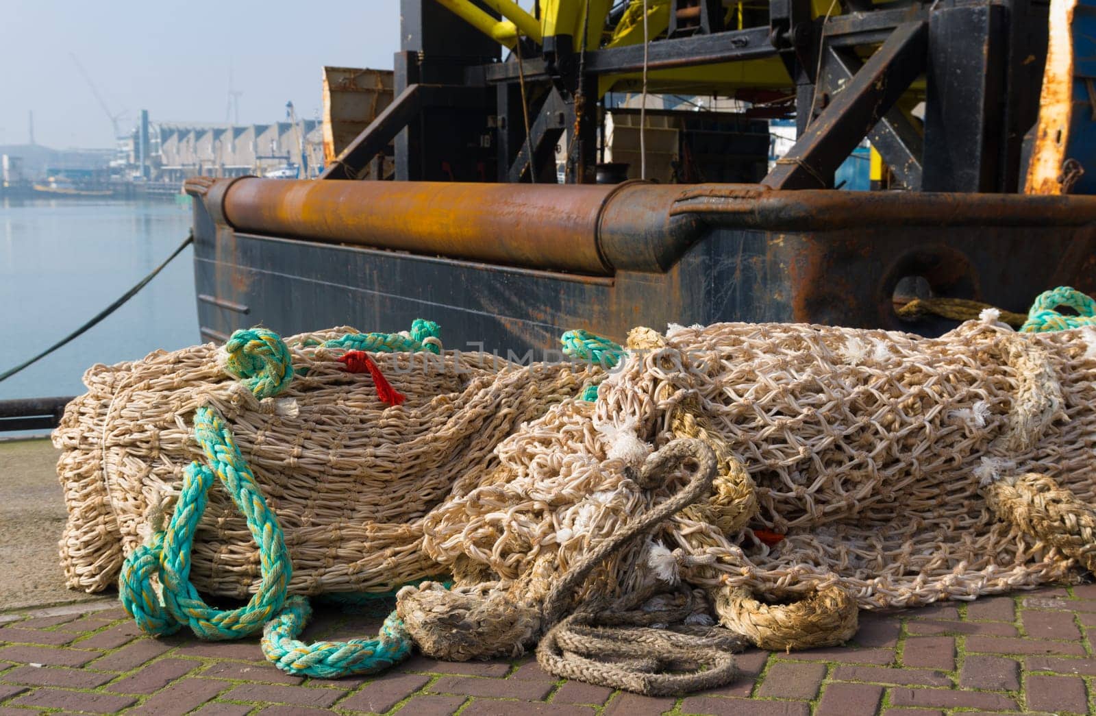 fishing nets in front of a fishing trawler in the scheveningen harbor in the netherlands