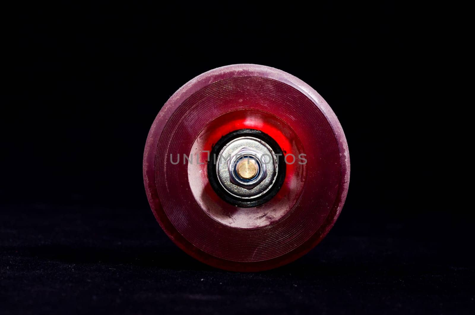 Old Vintage Consumed Skate Wheel on a Black Background