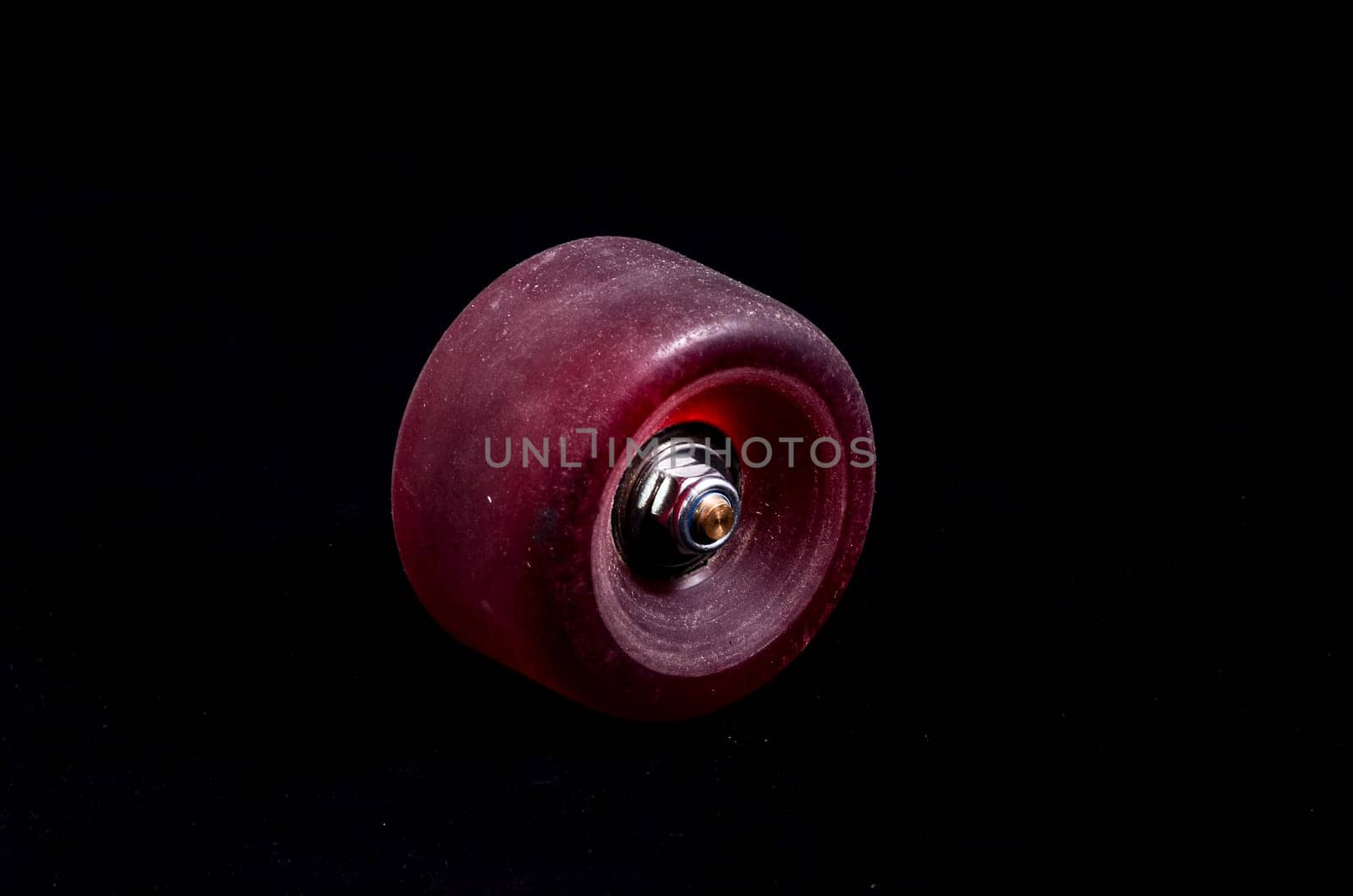 Old Vintage Consumed Skate Wheel on a Black Background
