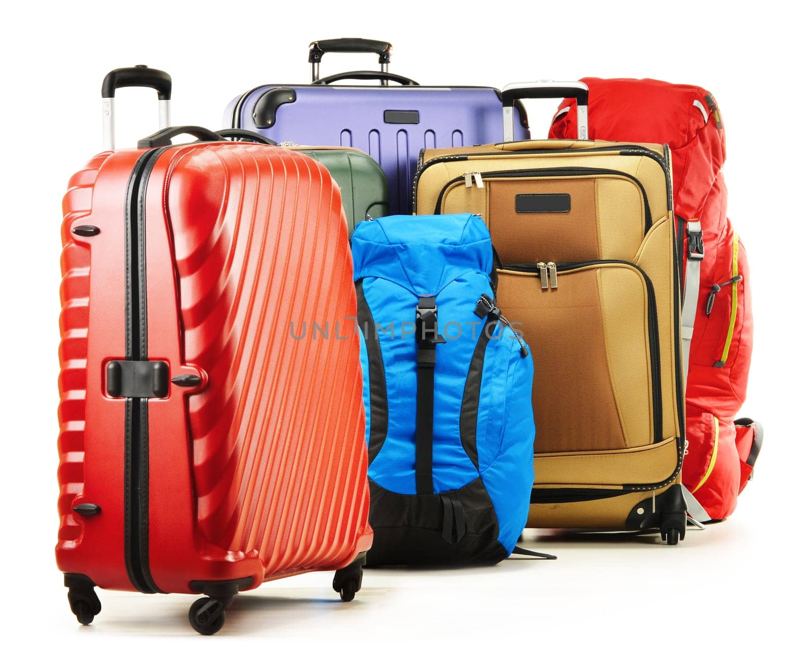Luggage consisting of large suitcases and rucksacks isolated on white.
