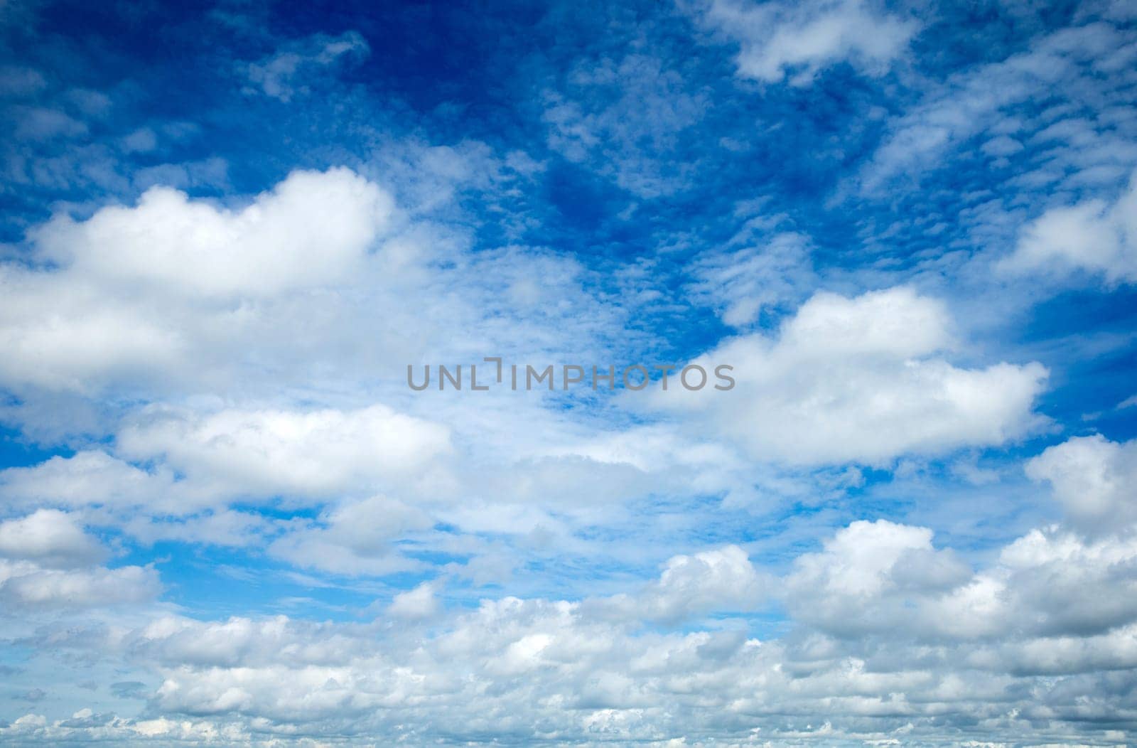 blue sky background with tiny clouds