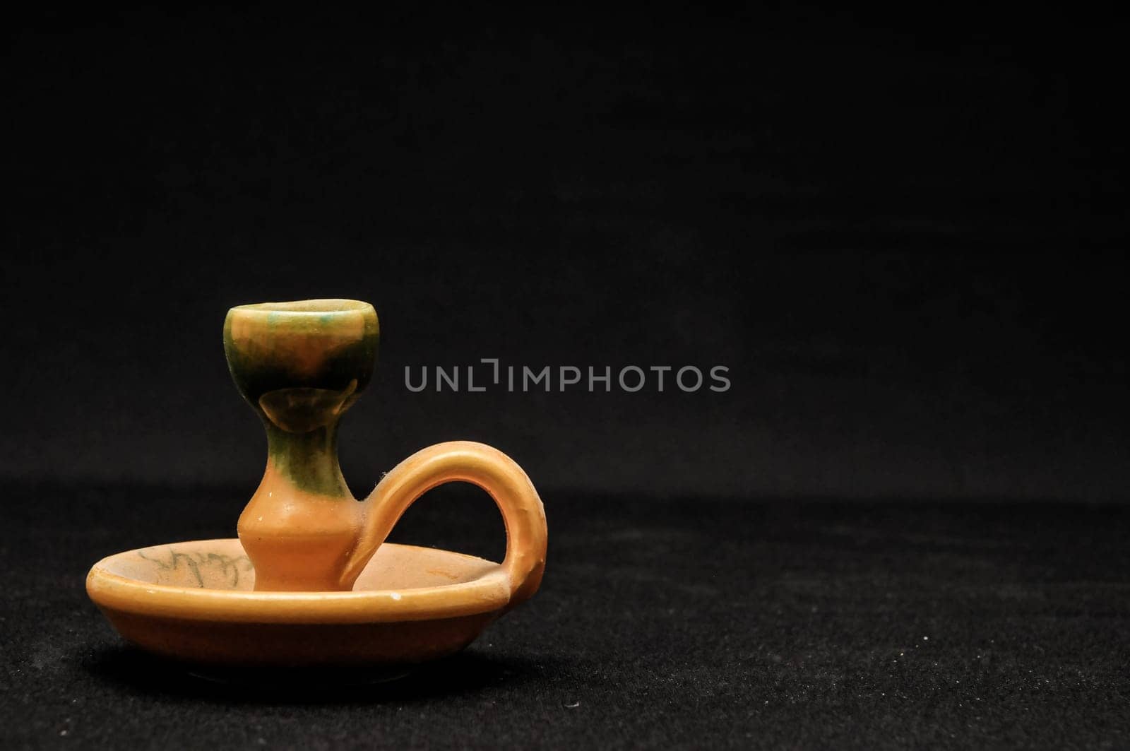 Colorful designed clay vase over a Black background