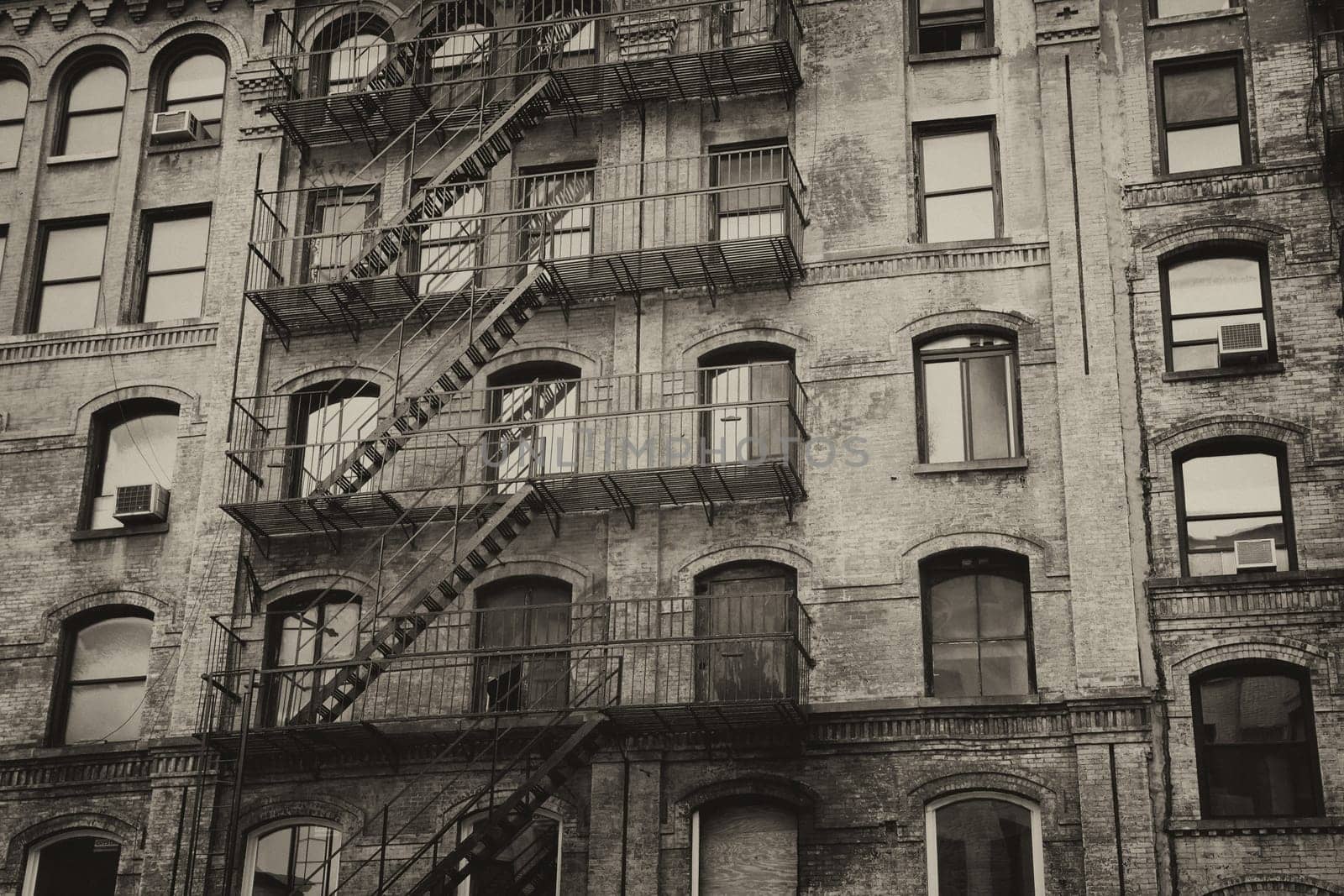 Vintage photo of old building with outdoor staircase (New York City, USA). Horizontally.