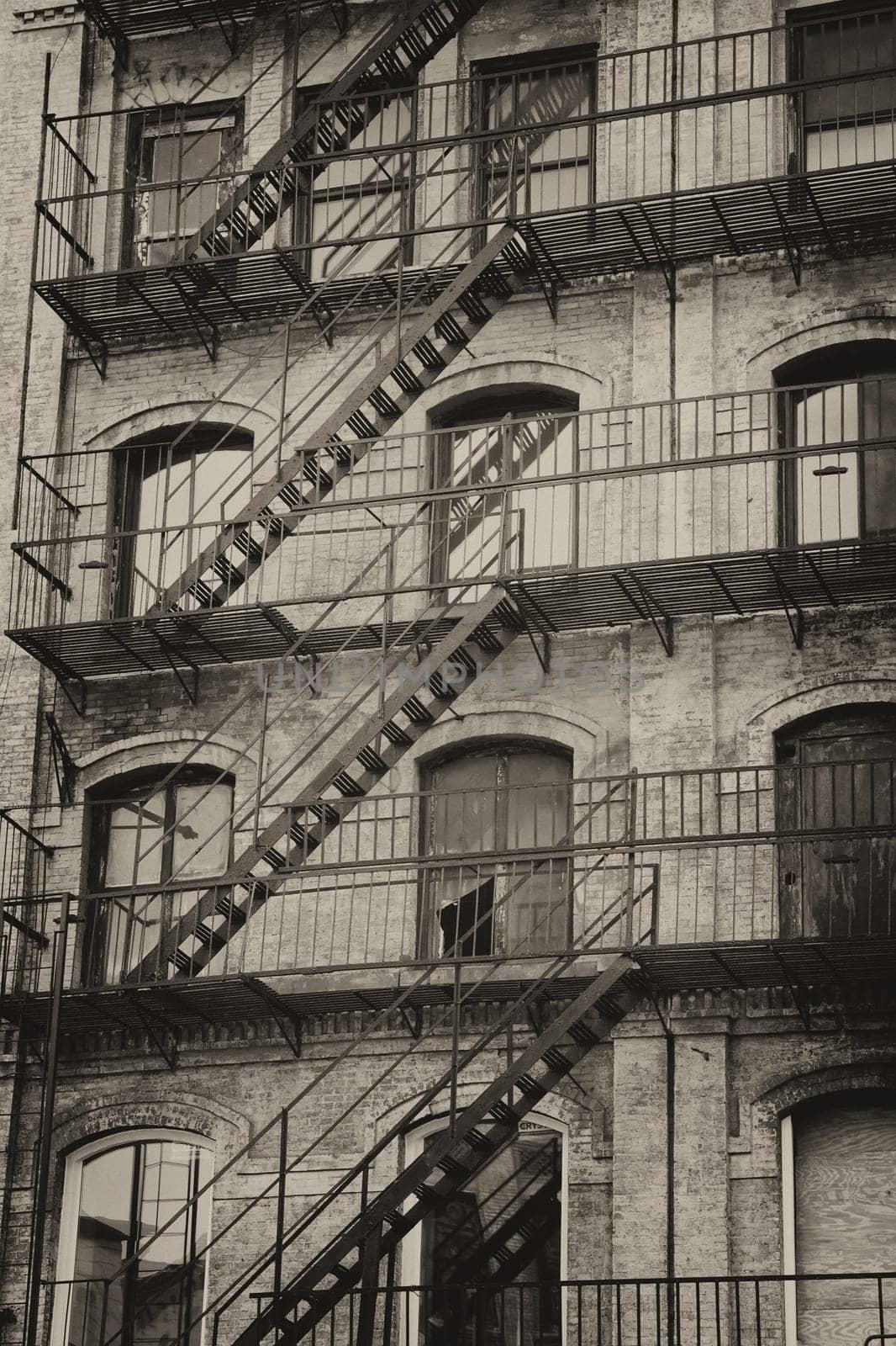 Vintage photo of old building with outdoor staircase (New York City, USA).Vertically.