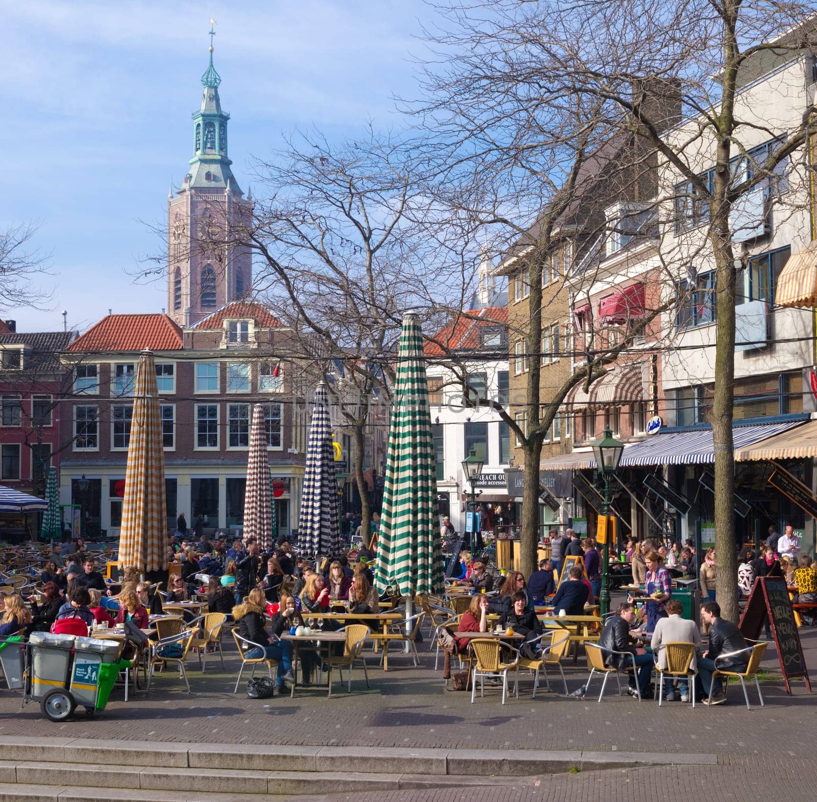 people enjoying the nice weather on terraces in the center of The Hague. The Hague is the third city in the Netherlands with over 500,000 residents