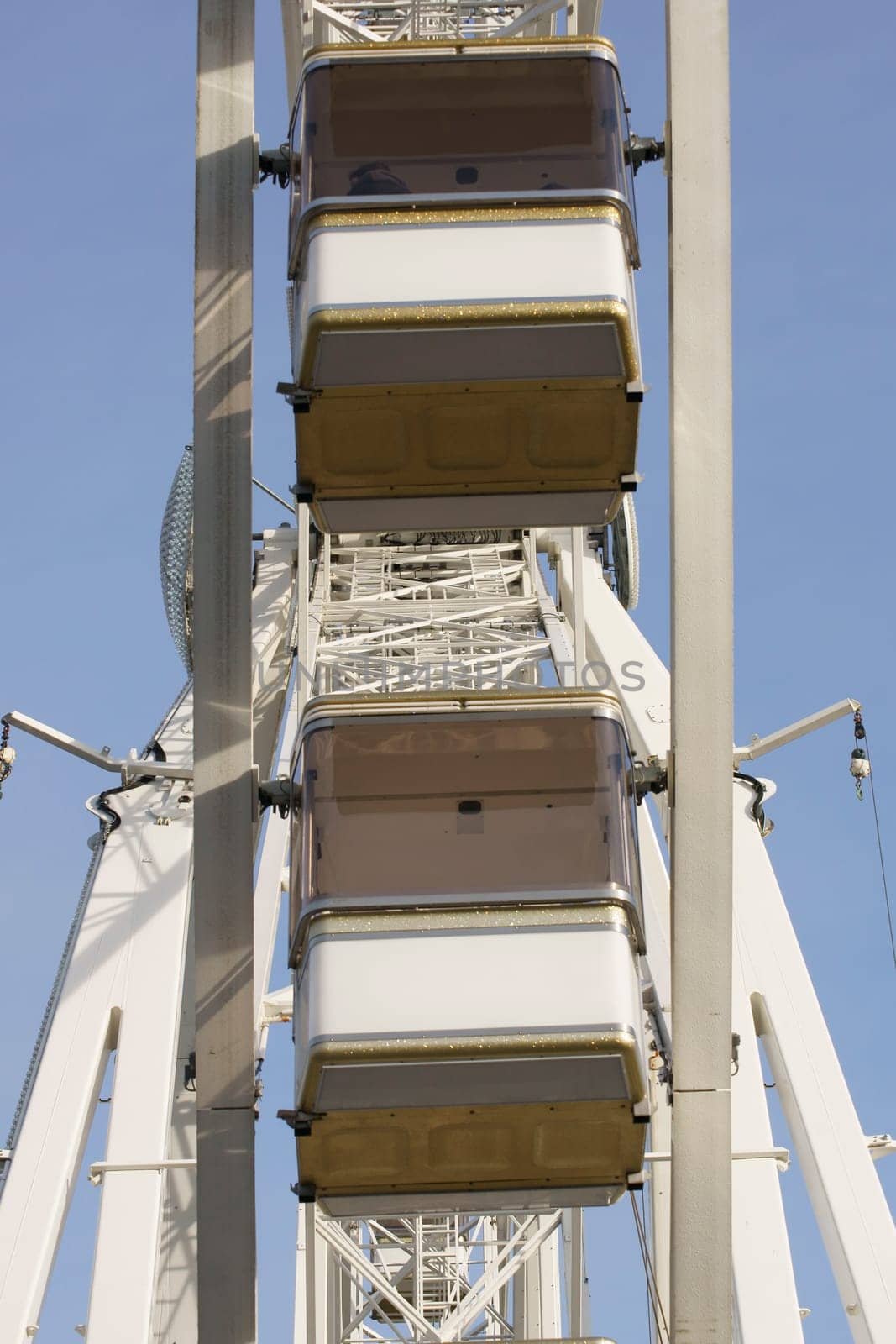 The photograph of gondolas of a Ferris wheel.