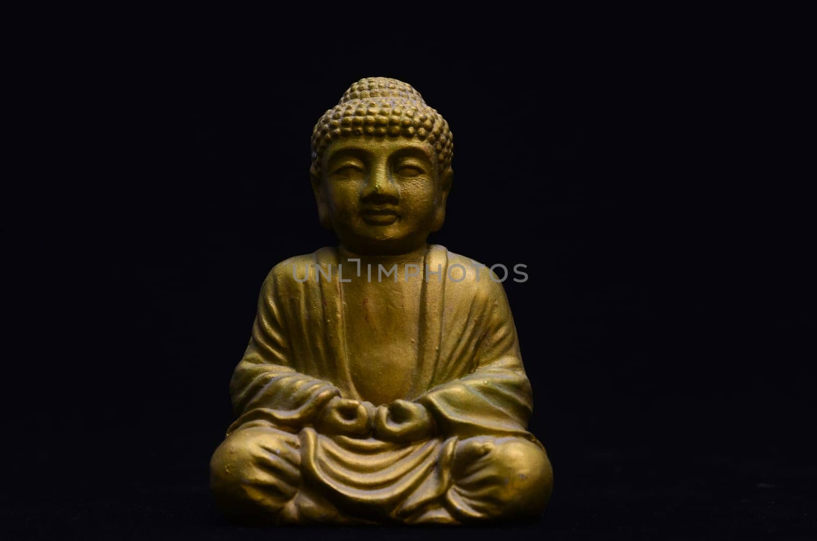 Golden Buddha Statue on a Black Background