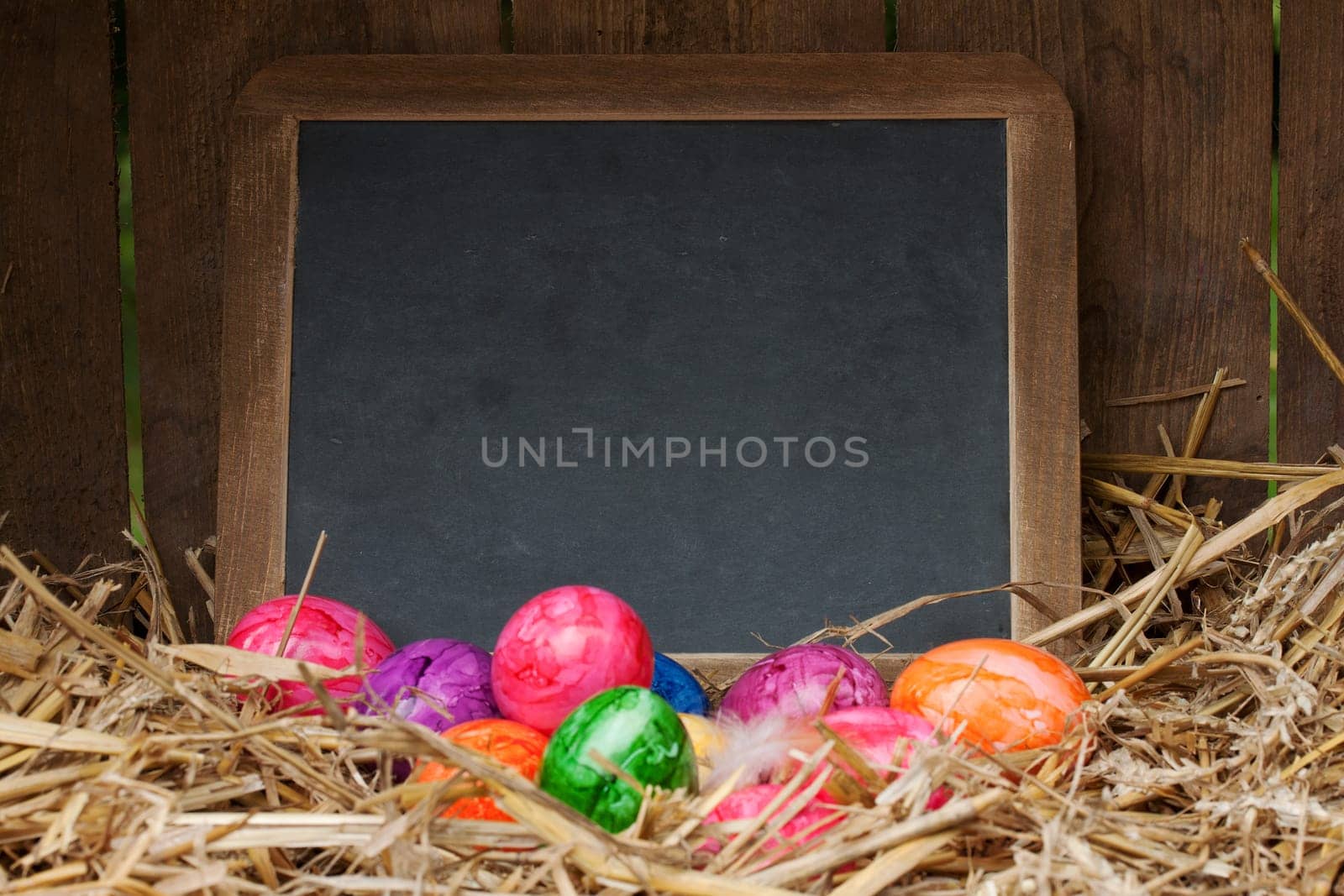 colorful easter eggs with slate board