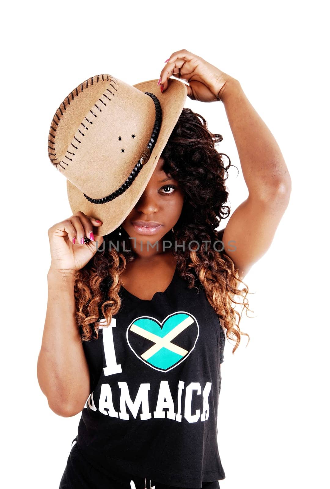 A pretty Jamaican woman in exercise outfit and a cowboy hat on her long.black and brown hair standing isolated for white background..