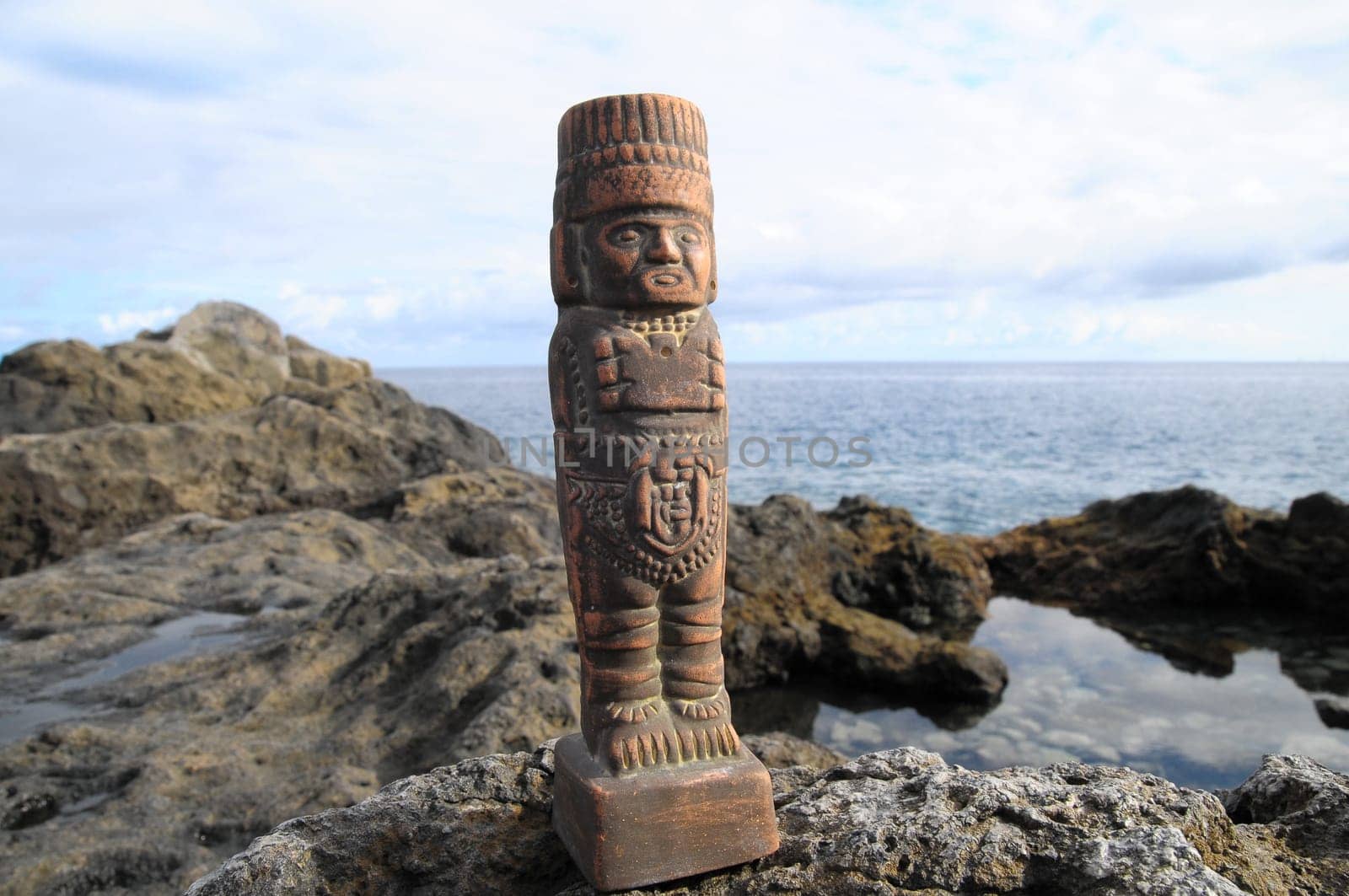 Ancient Maya Statue on the Rocks near the Ocean