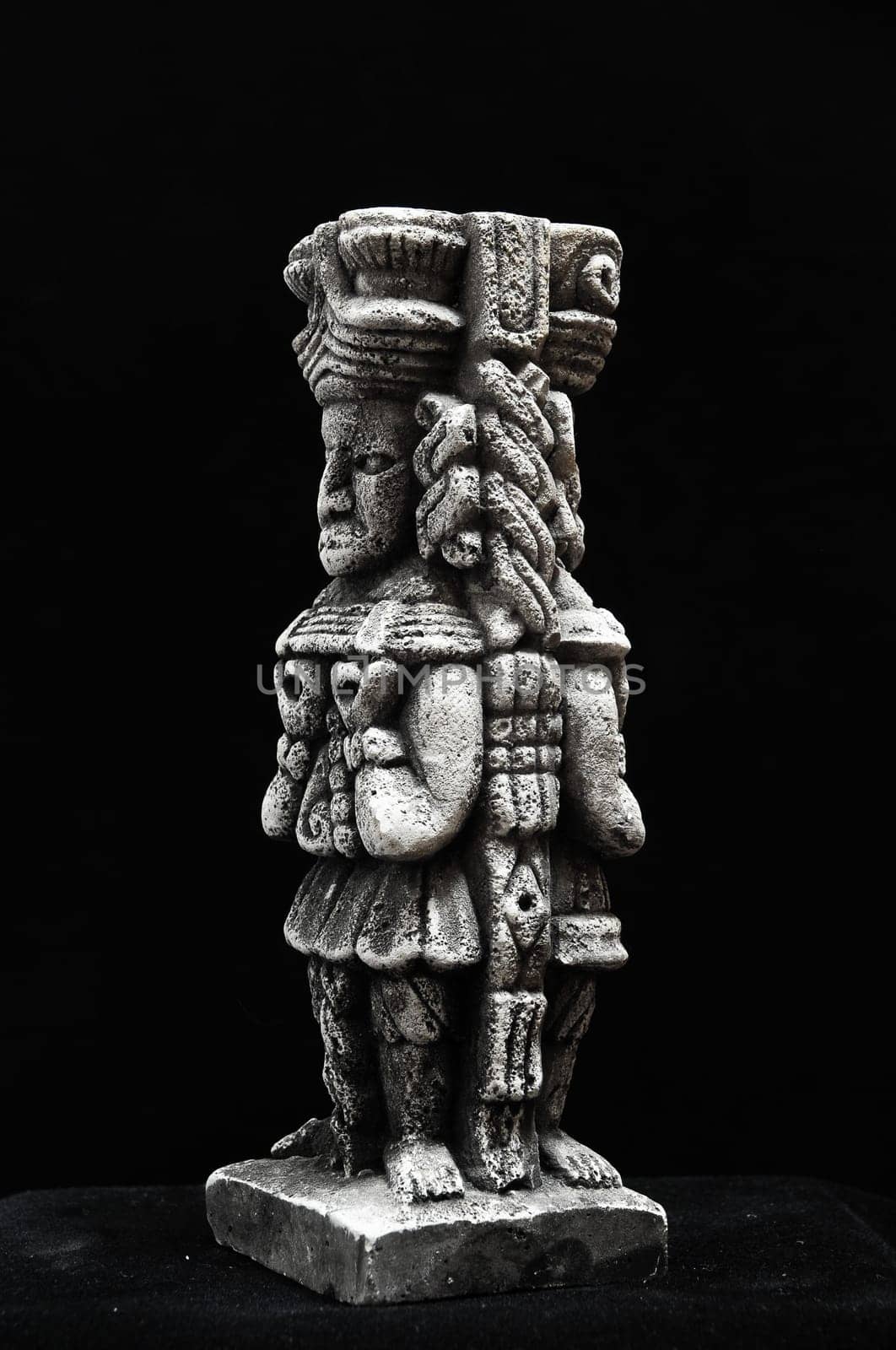One Ancient Mayan Statue on a Black Background