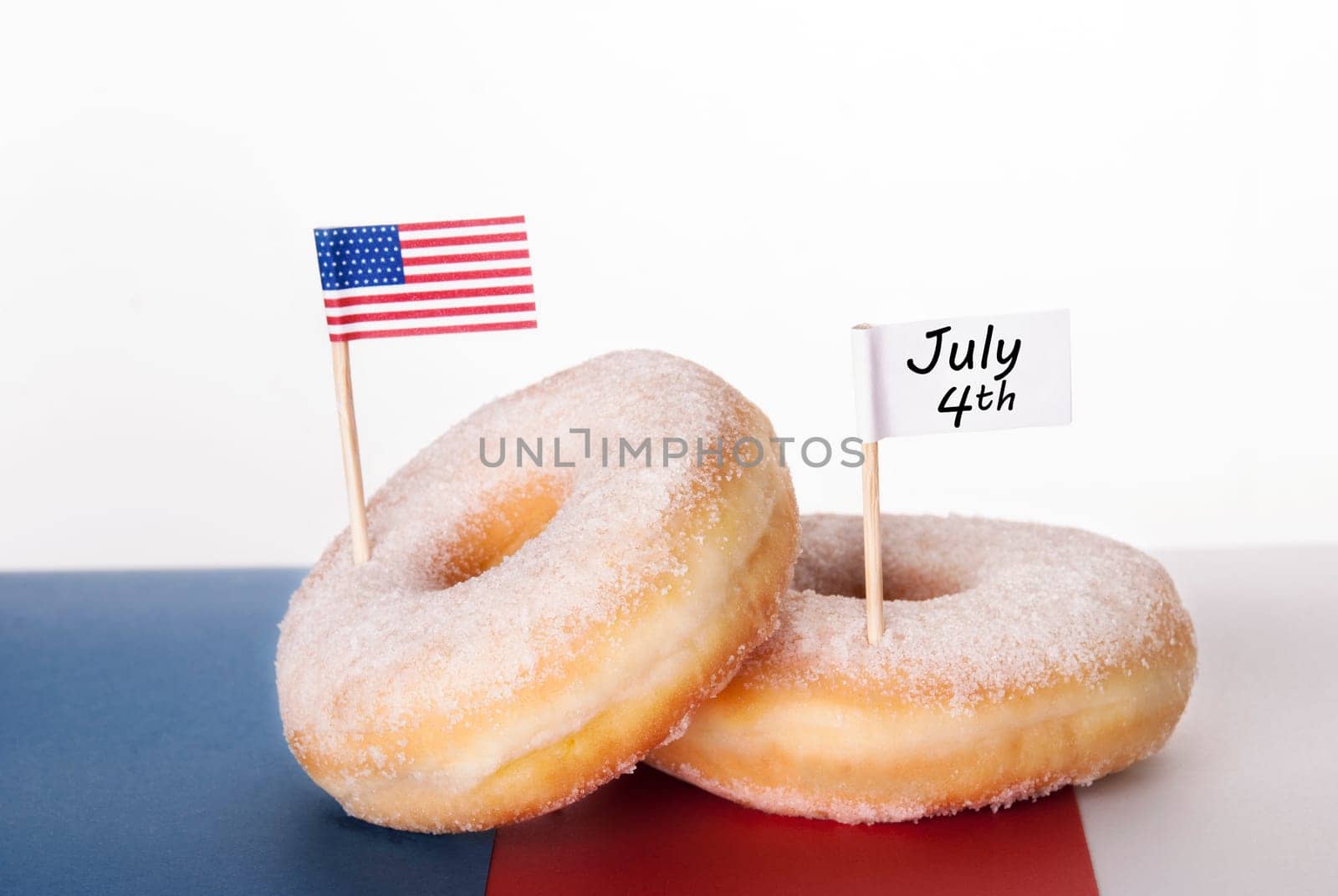 Two Donuts with American Flag and white Banner with July 4th, Isolated