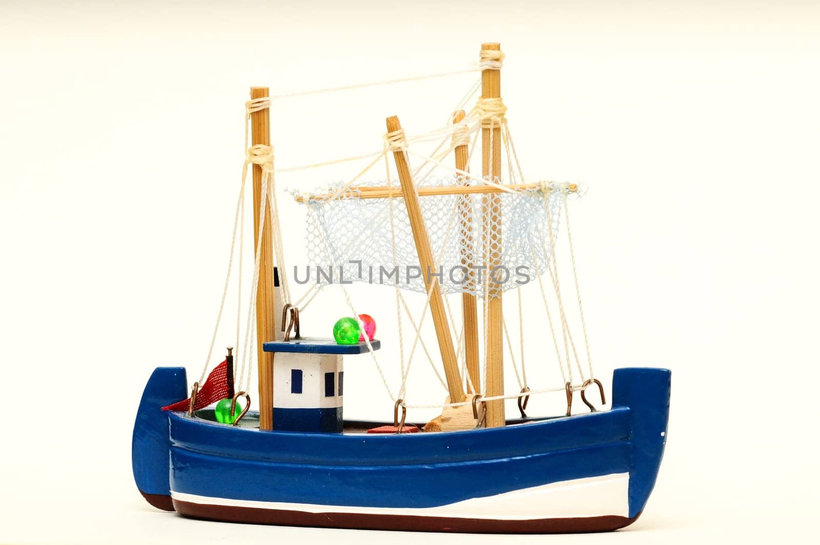 Beautiful miniature ship. Wooden sailship figurine. Antique model sailing boat isolated on white
