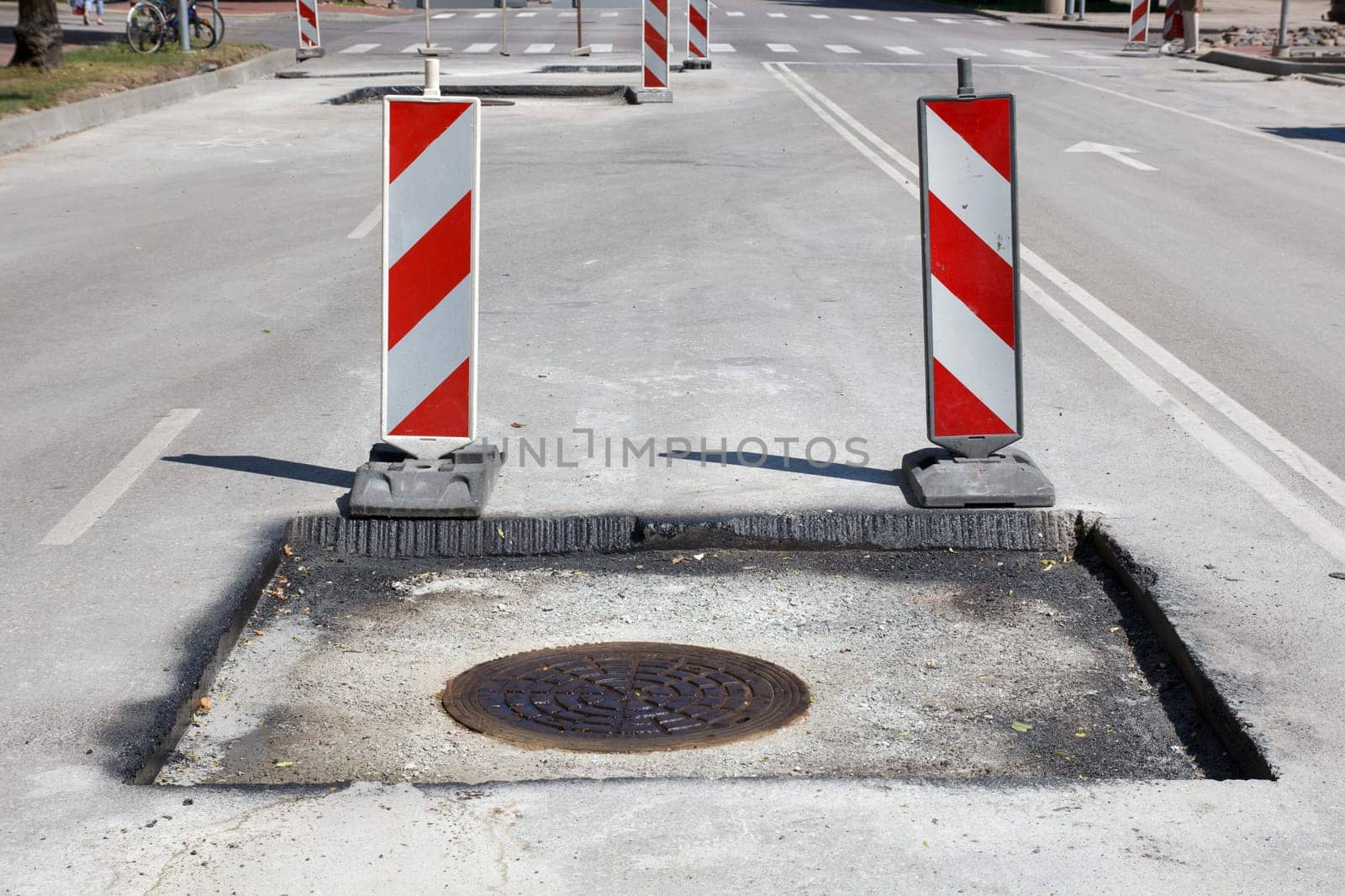 street repair, new asphalt with sewage wells