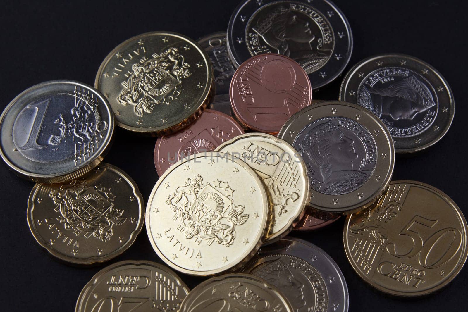 Latvia EURO on black background. Latvia replaced its previous currency, the lats, with the euro on 1 January 2014