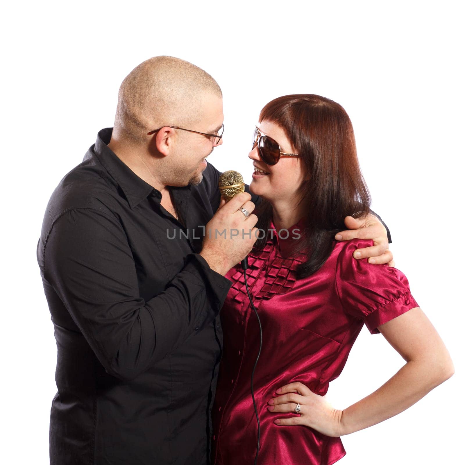 middle age couple  singing in microphone on white background