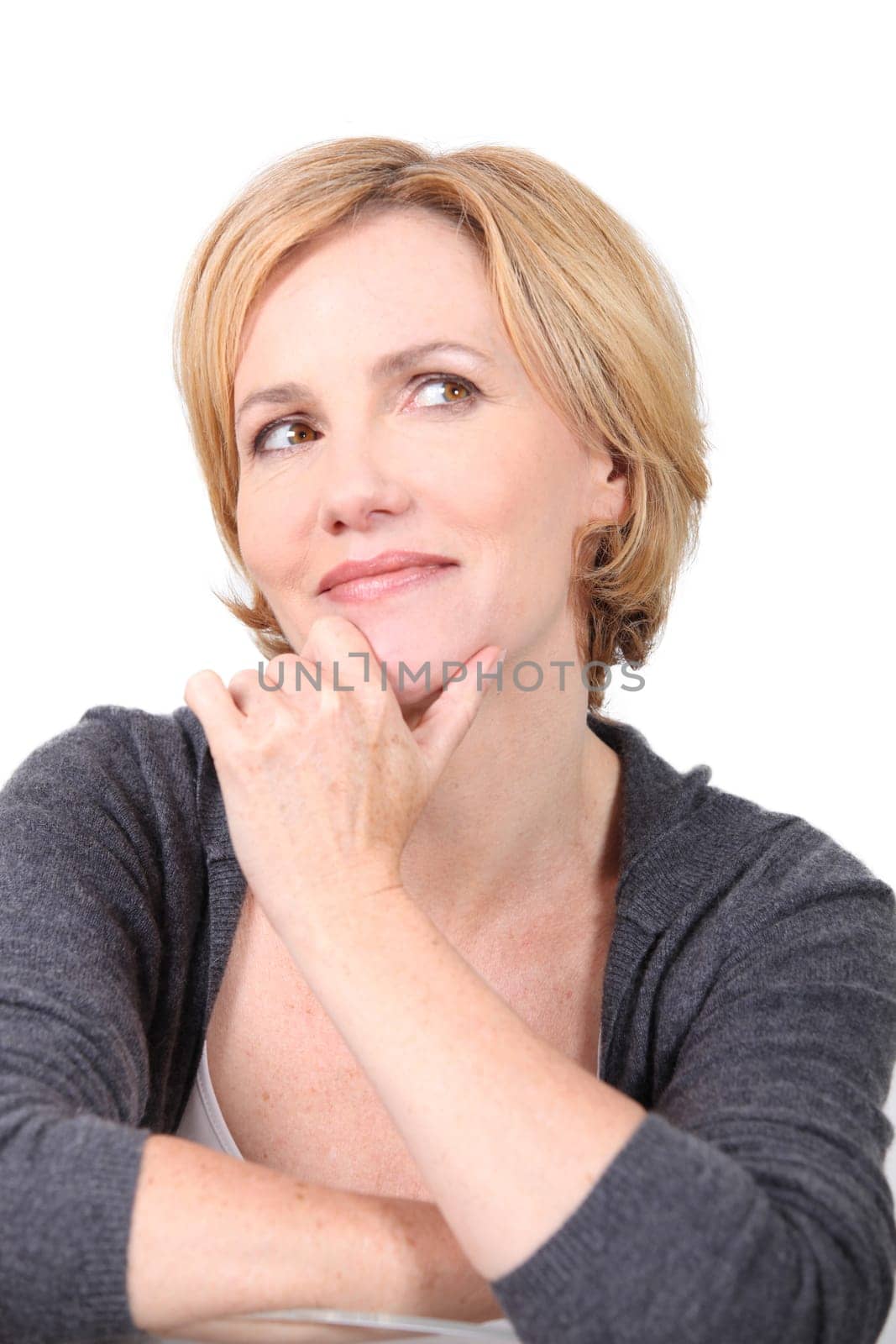 Portrait of blond woman with hand to face