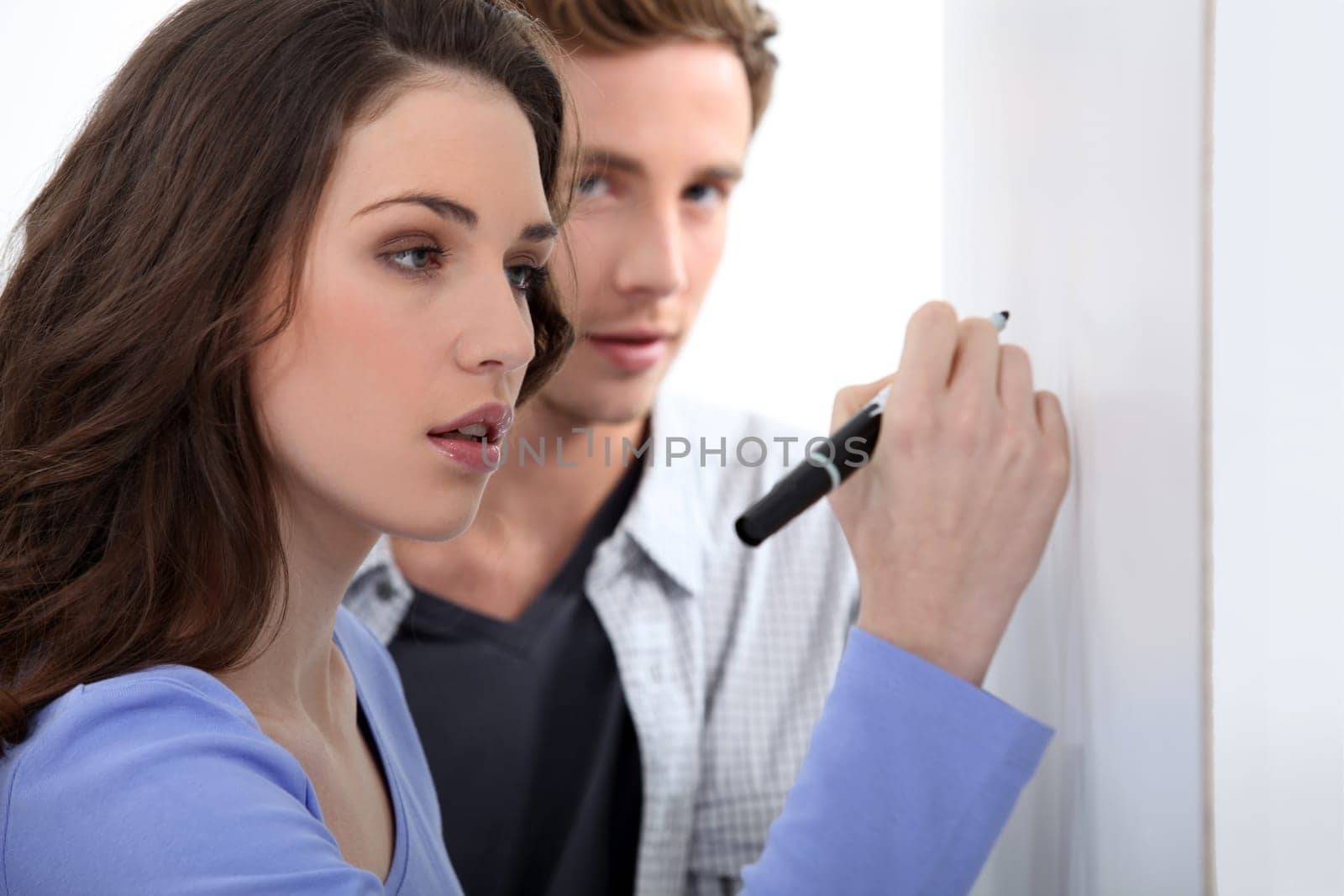 Woman writing on blank poster