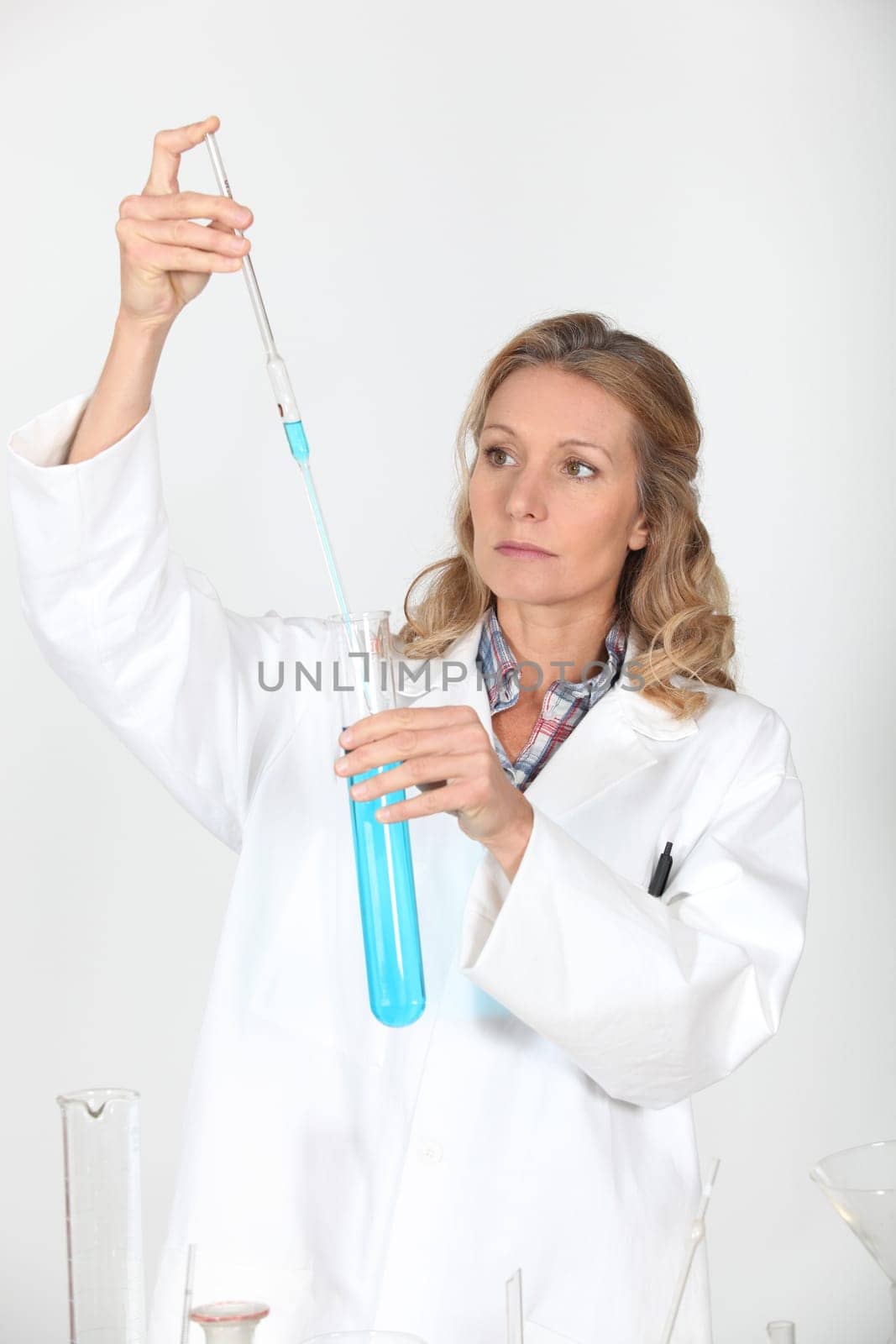 female biologist holding pipette and test tube