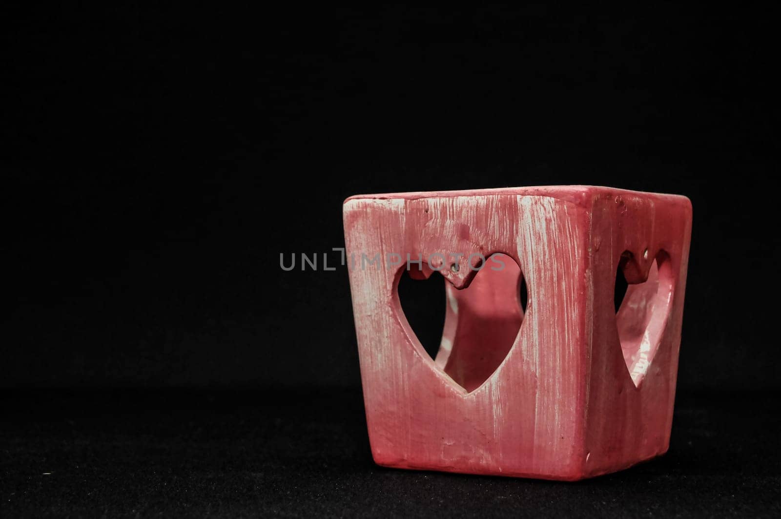Colorful designed clay vase over a Black background