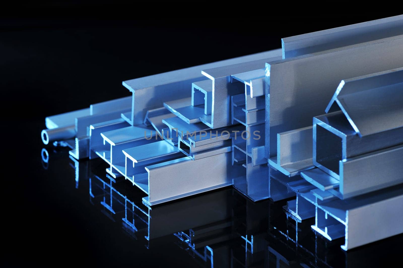 many different aluminium profile strips in blue spotlight