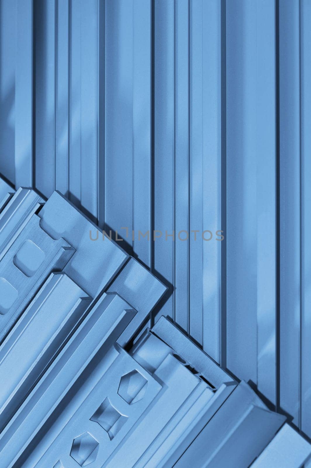 many different aluminium profile strips in blue light