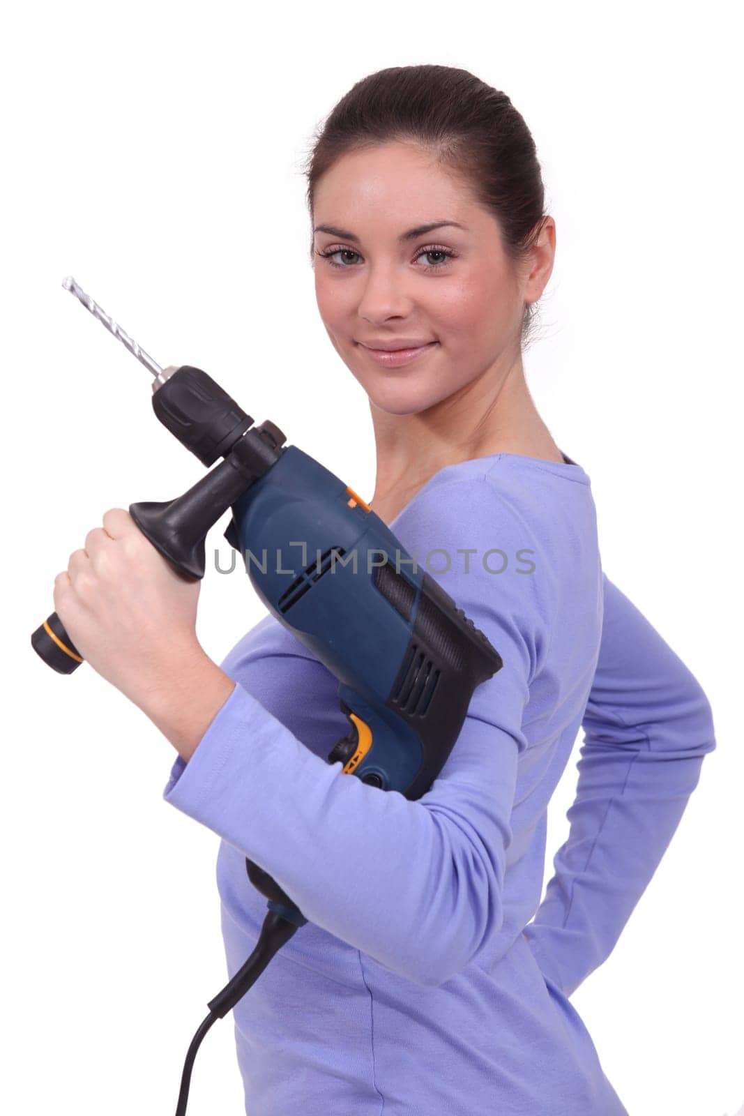 A woman holding a drill.